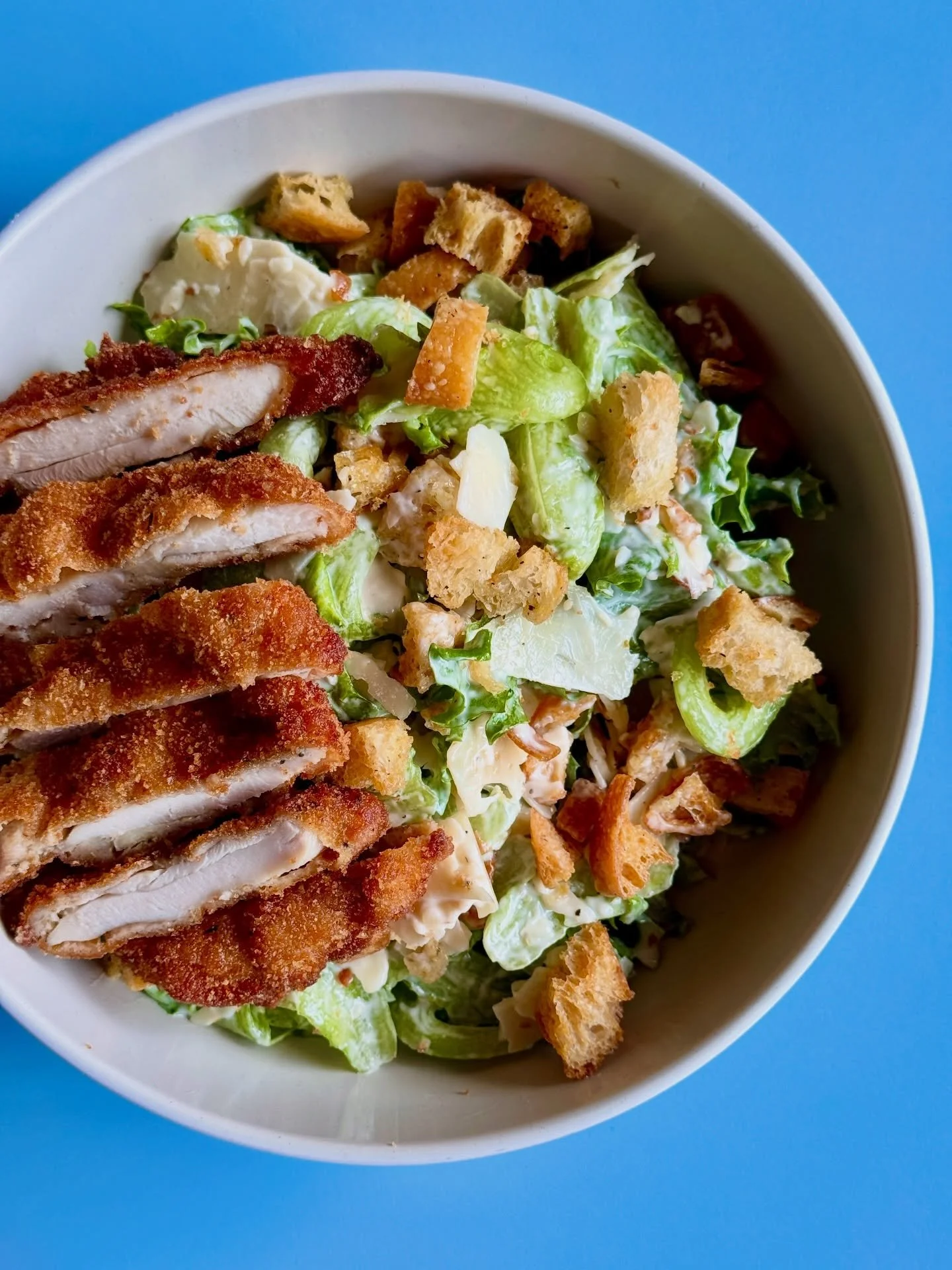 Newly unwrapped for spring! ✨CHICKEN CAESAR SALAD✨ Think juicy chicken milanese on a bed of hearty greens, shaved parmesan, and house-made croutons tossed in a house-made Caesar dressing. 

🛵On the go? We&rsquo;re still offering it wrapped up in a w
