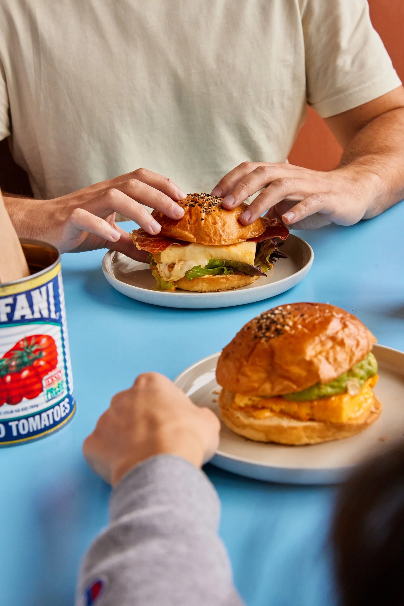 COUPLE ENJOYING A BREAKFAST SANDWICH
