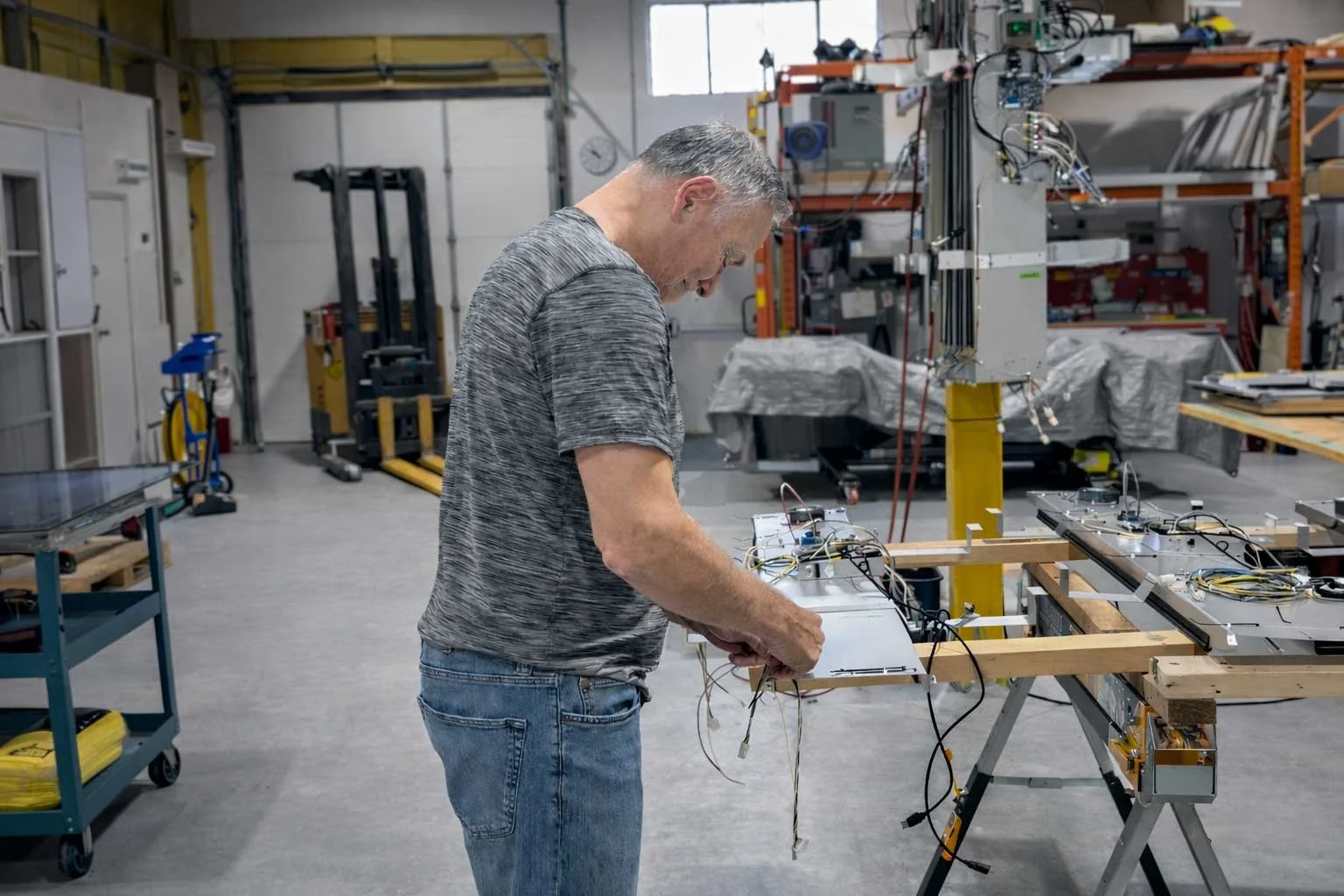 B&F Solutions Inc technician performing hands-on assembly of an indoor digital signage unit inside the manufacturing facility, demonstrating reliable craftsmanship and attention to detail.