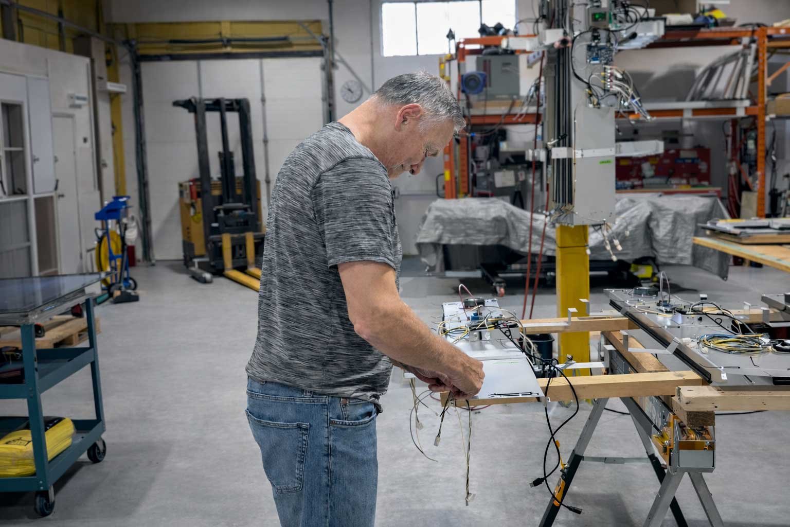 B&F Solutions Inc technician assembling indoor digital signage hardware on the production floor.
