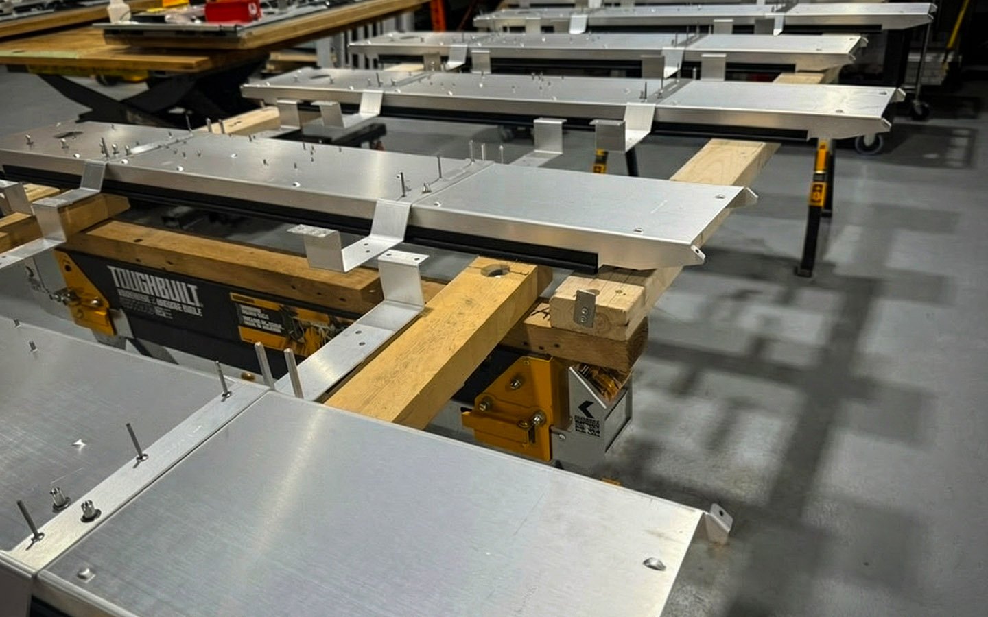 Custom-fabricated metal housings staged for indoor digital signage assembly at B&F Solutions Inc.