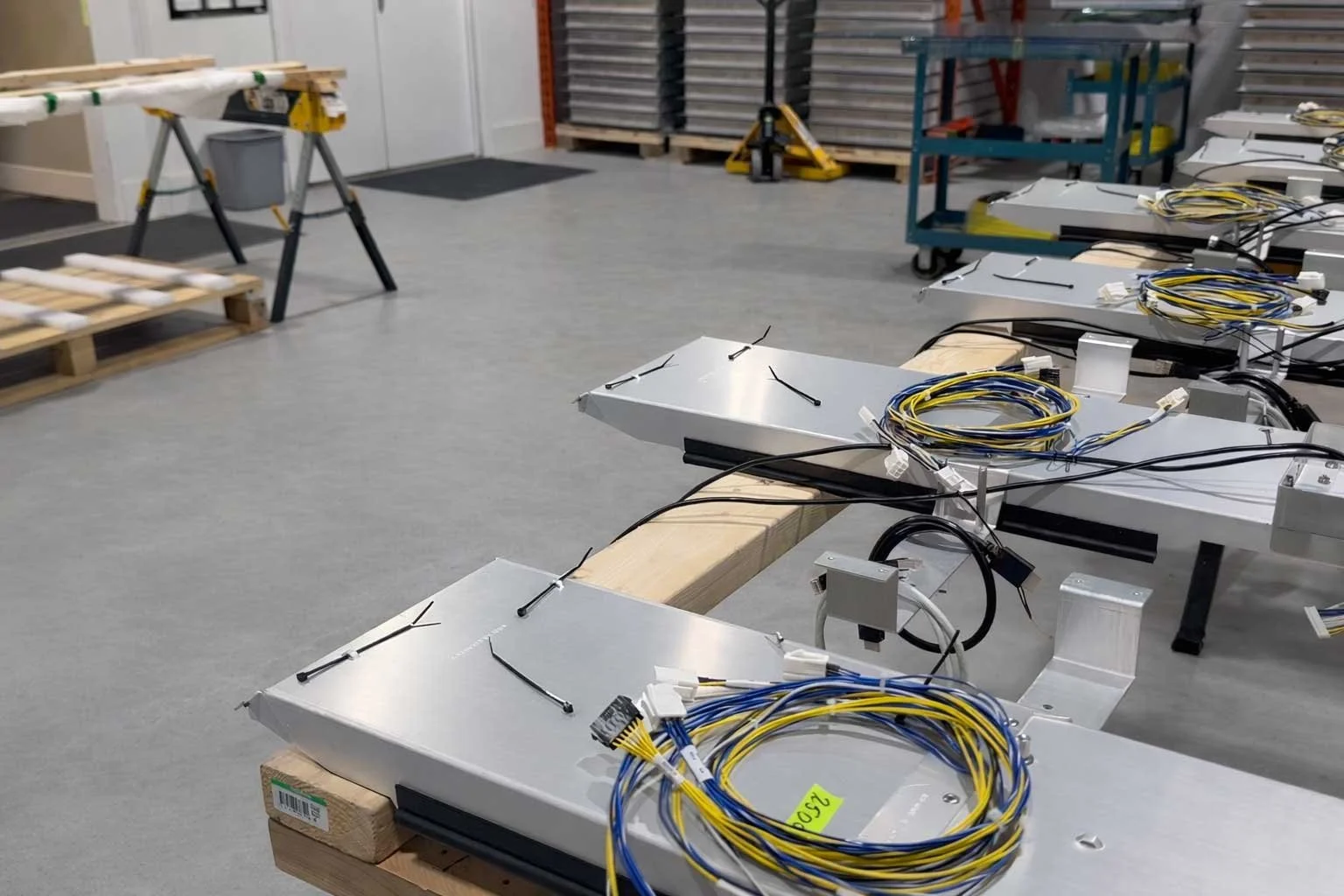 Indoor digital signage panels staged on worktables during assembly inside B&F Solutions Inc’s manufacturing facility.