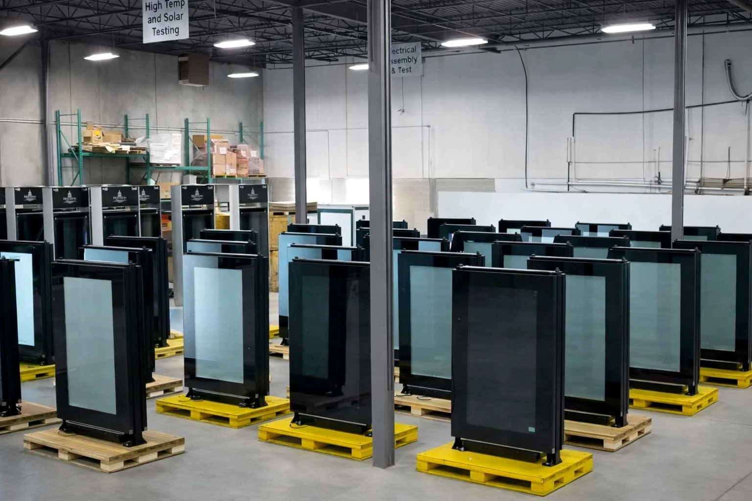 Finished indoor digital signage displays staged on pallets, ready for deployment from B&F Solutions Inc.