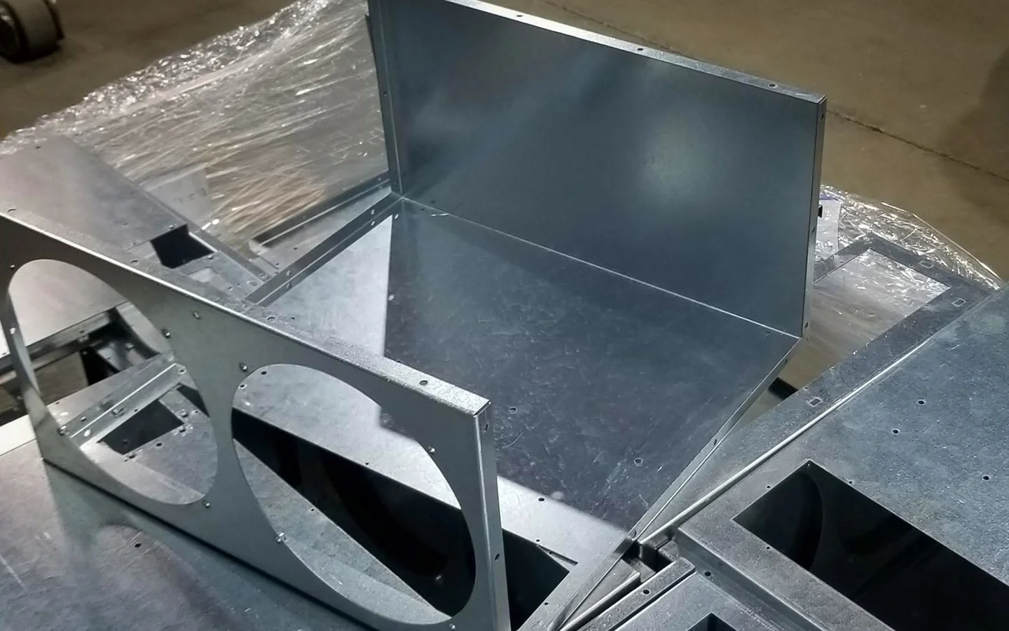 Close-up of precision-fabricated metal components used in indoor digital signage enclosures by B&F Solutions Inc.
