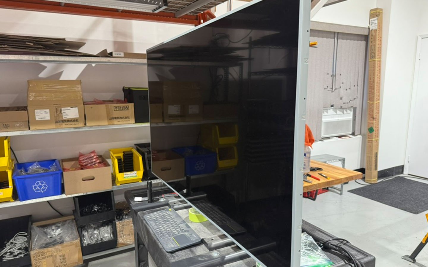 Staged components and materials for indoor digital signage manufacturing inside B&F Solutions Inc’s fabrication facility.