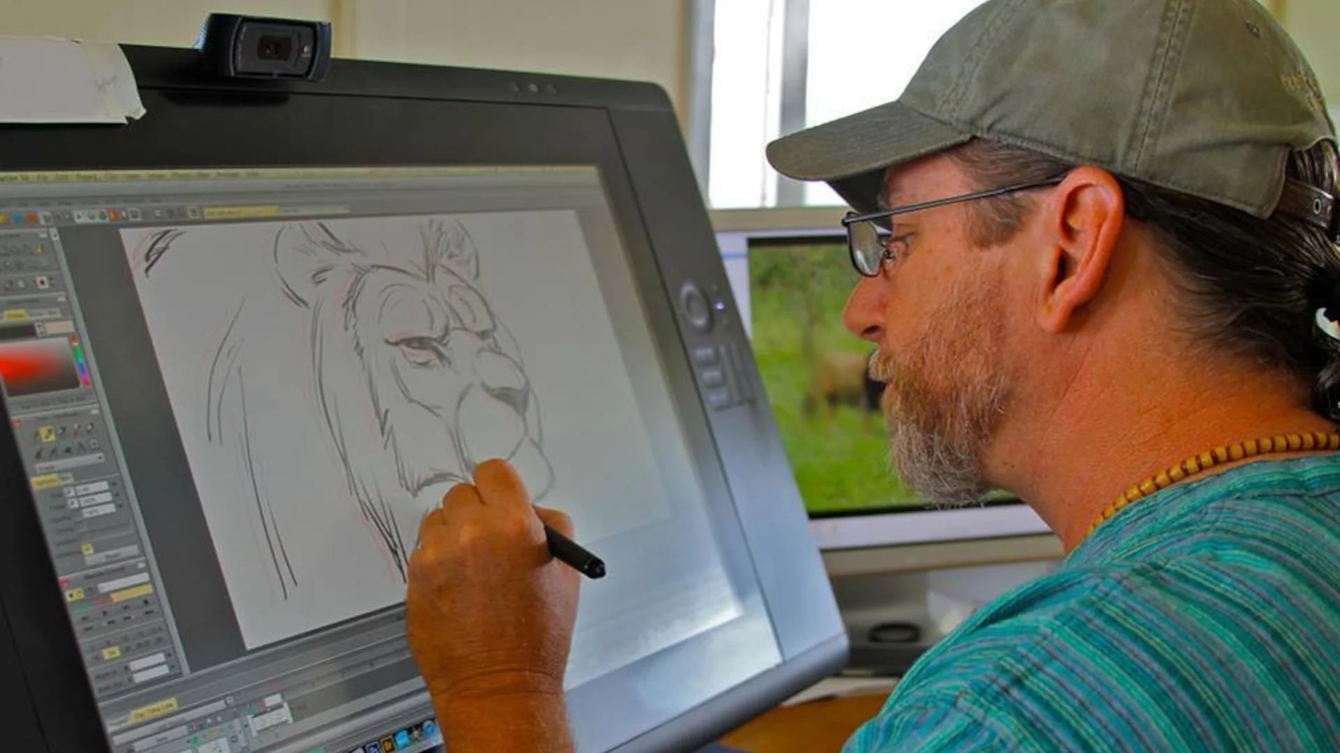Guy drawing a lion on a computer screen.