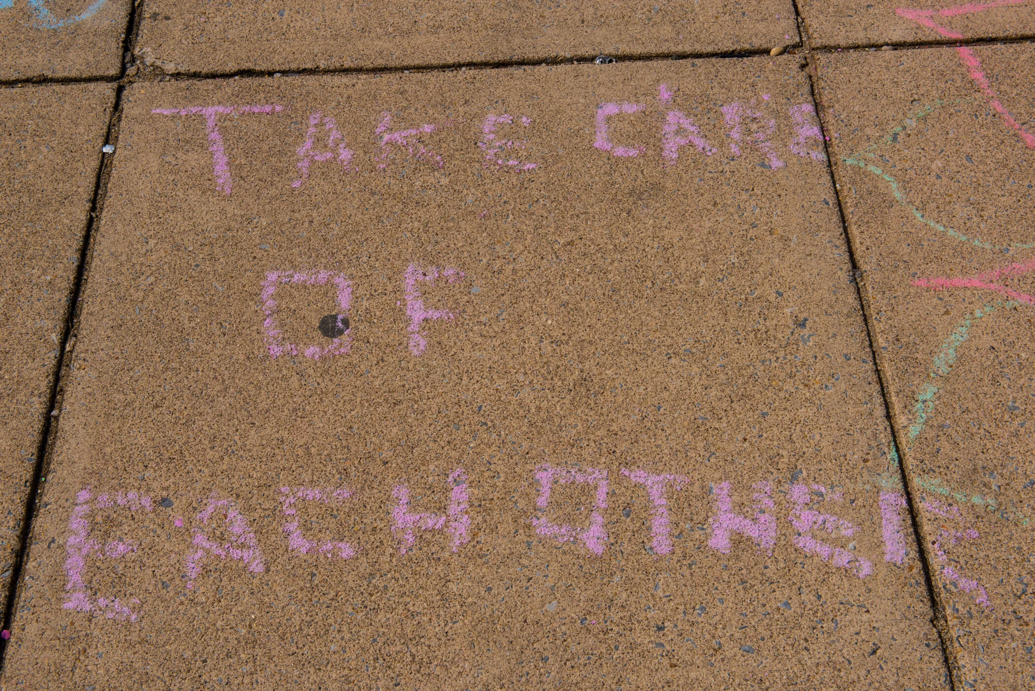 Pink chalk written on concrete sidewalk reads, "TAKE CAN" and "COOL PARENTS!"