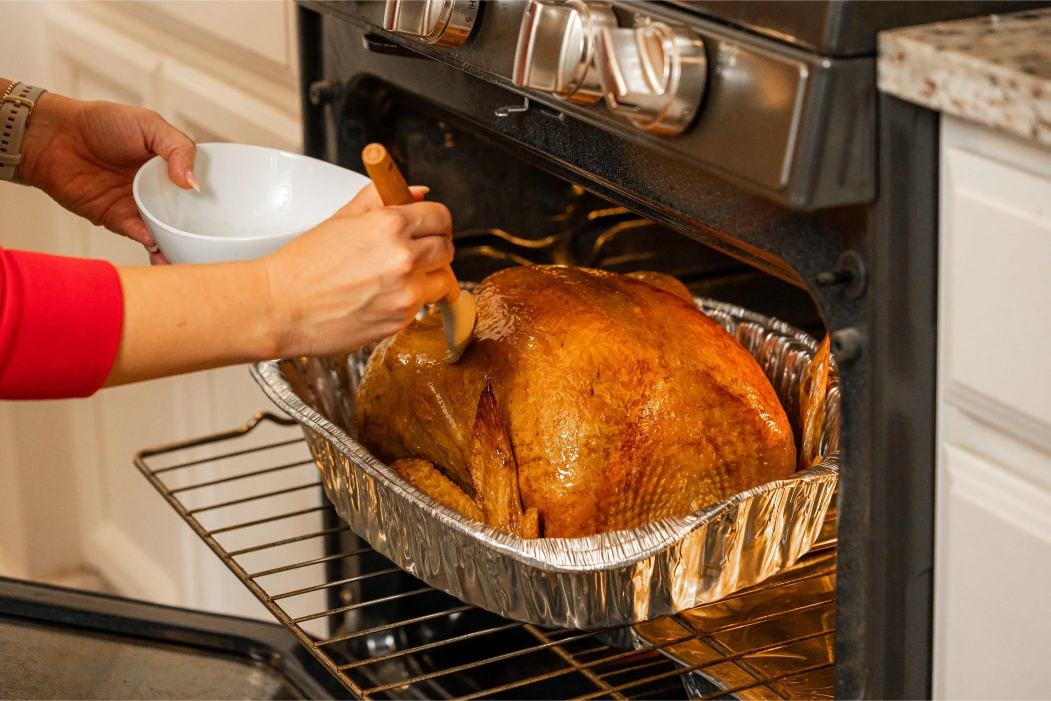 Heat and serve Thanksgiving turkey going into a home oven in its oven-safe pan