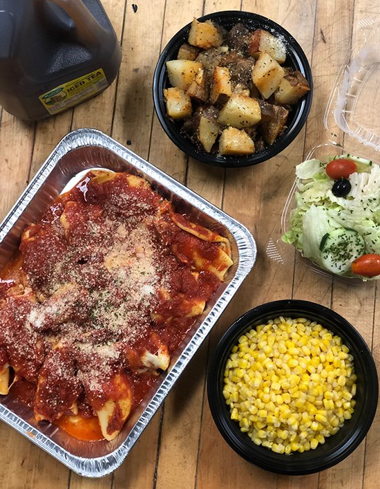 Stuffed shells, side of corn and roasted potatoes - perfect homemade takeout food