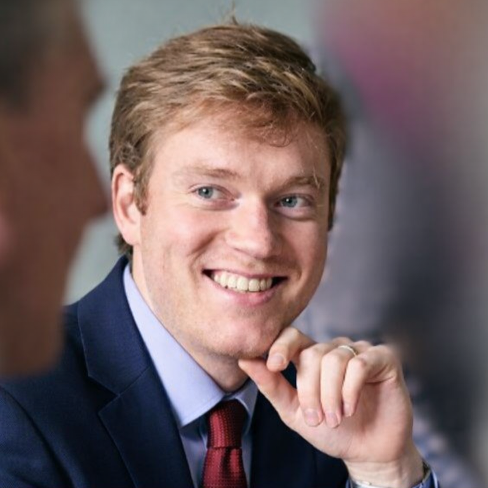Man in suit looking at client during review meeting