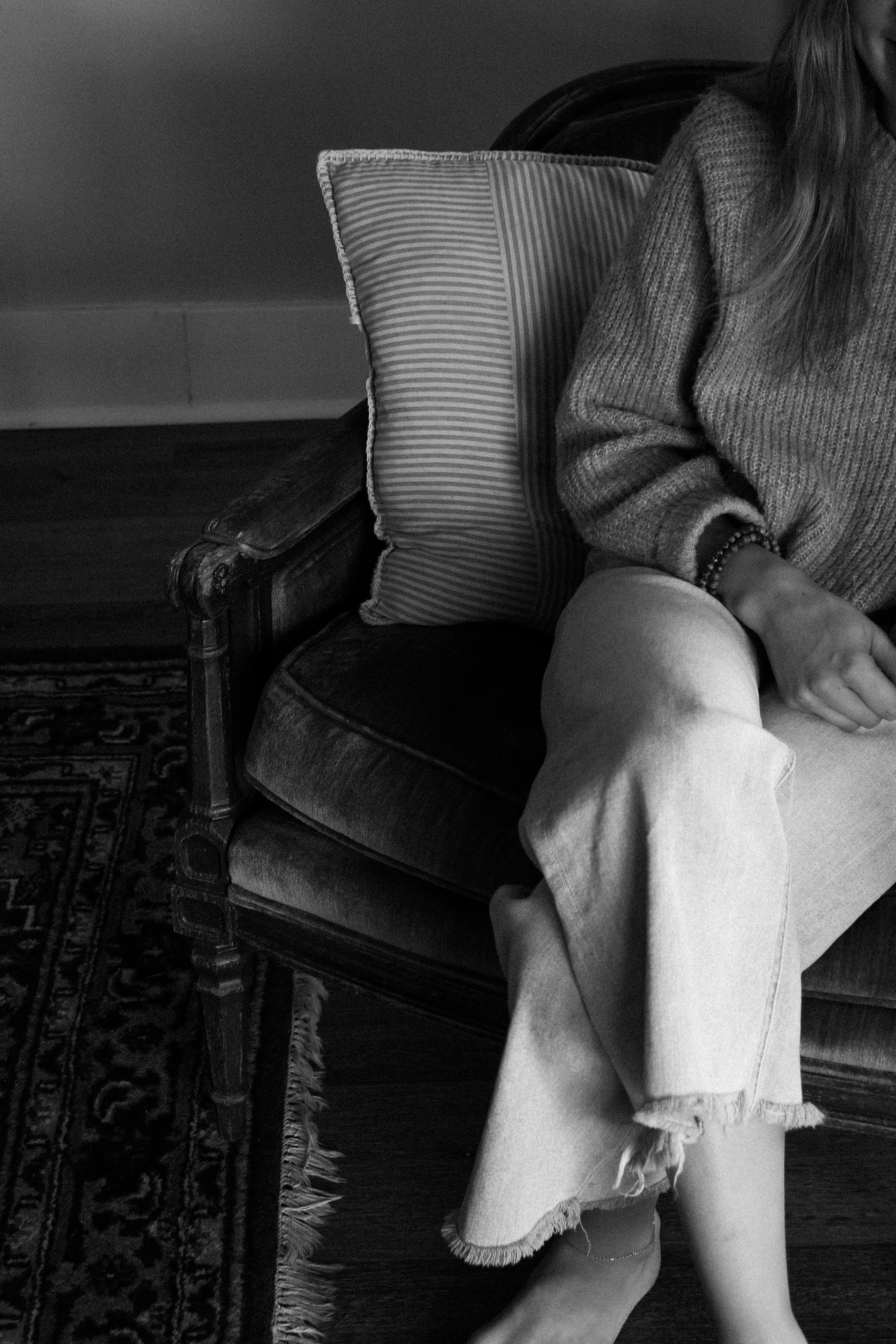 Black and white photo of a woman sitting in a chair