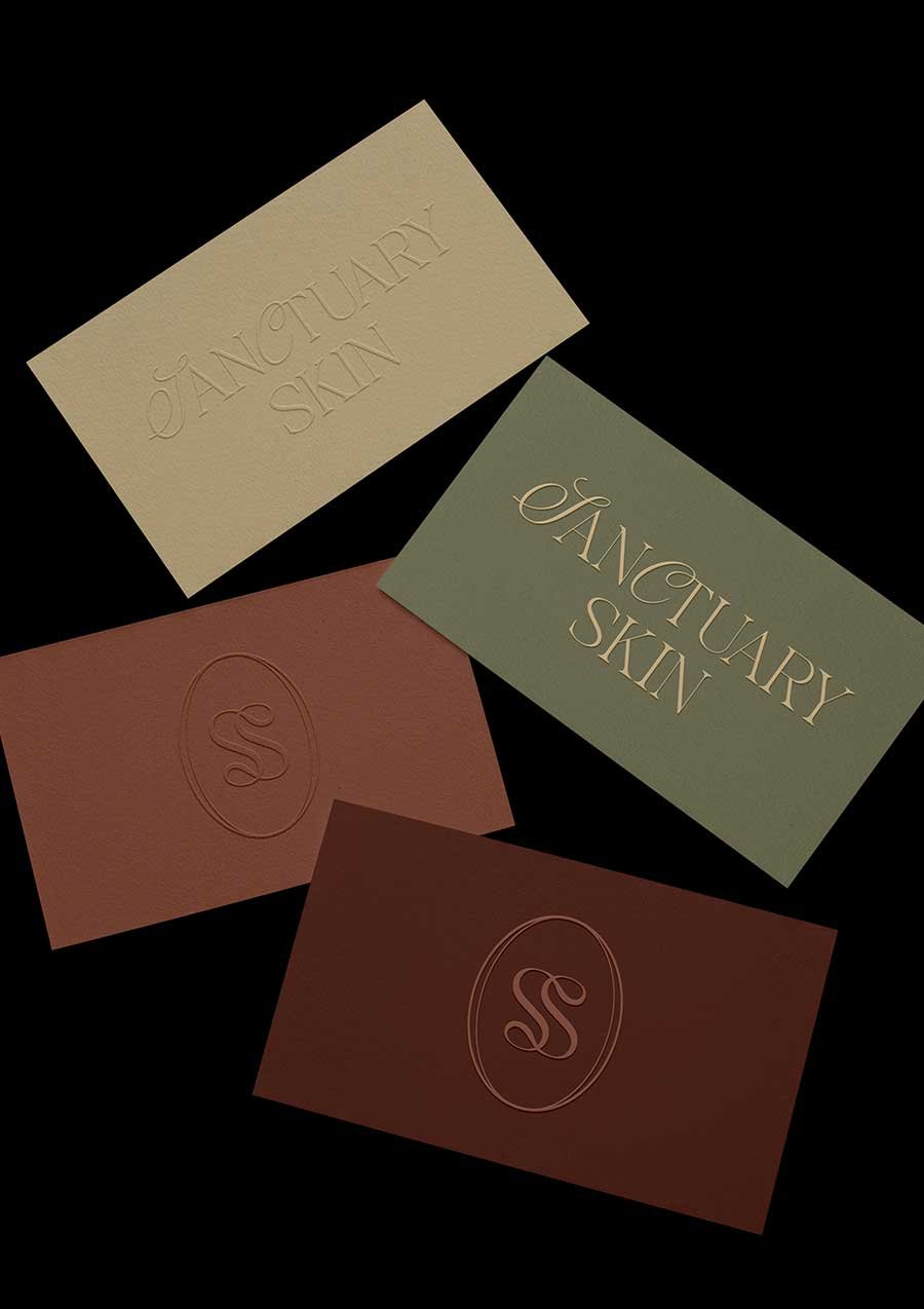 Sanctuary Skin logo designs on branded cards printed in rich color palette
