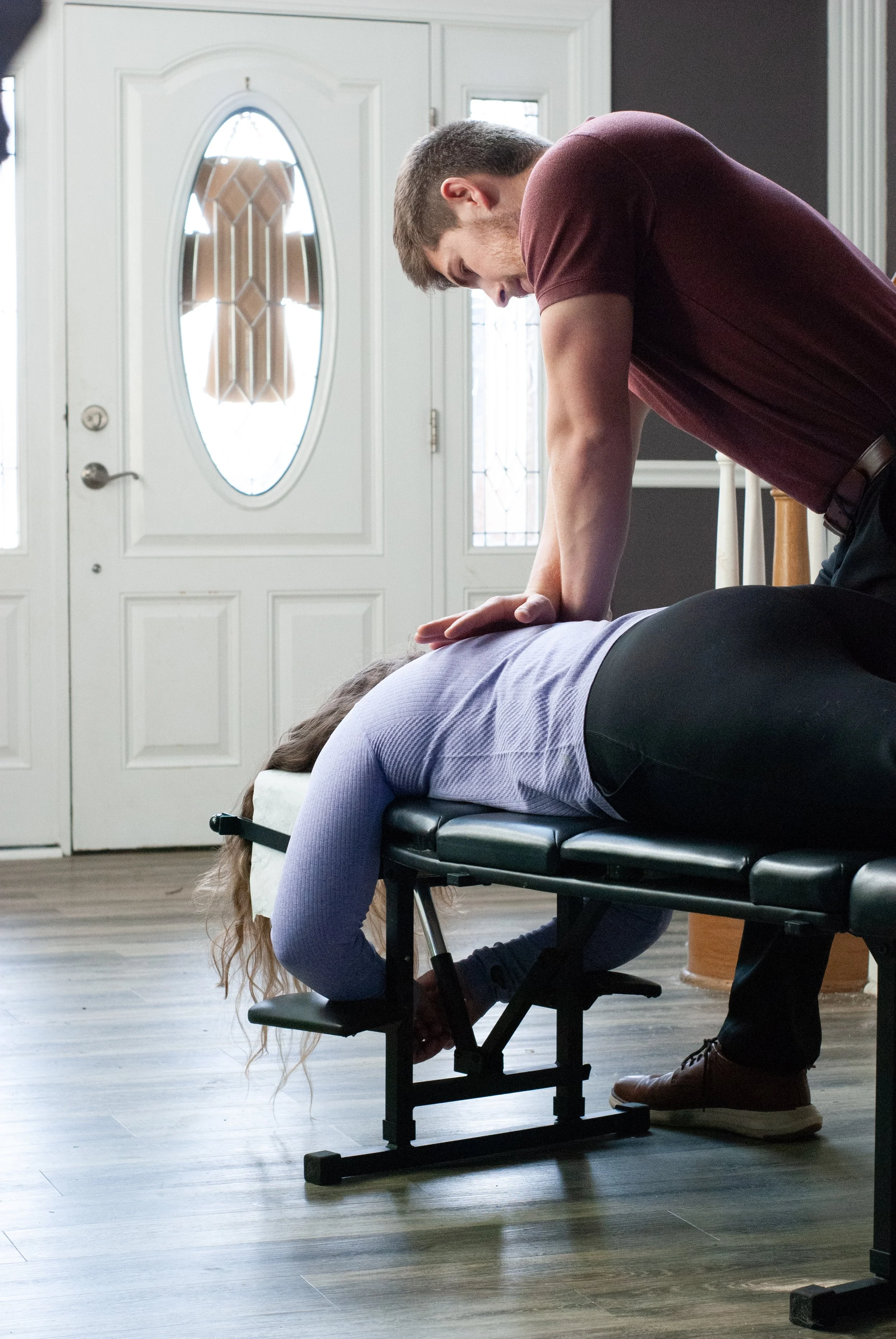 Dr. Talon adjusting a patient in their house