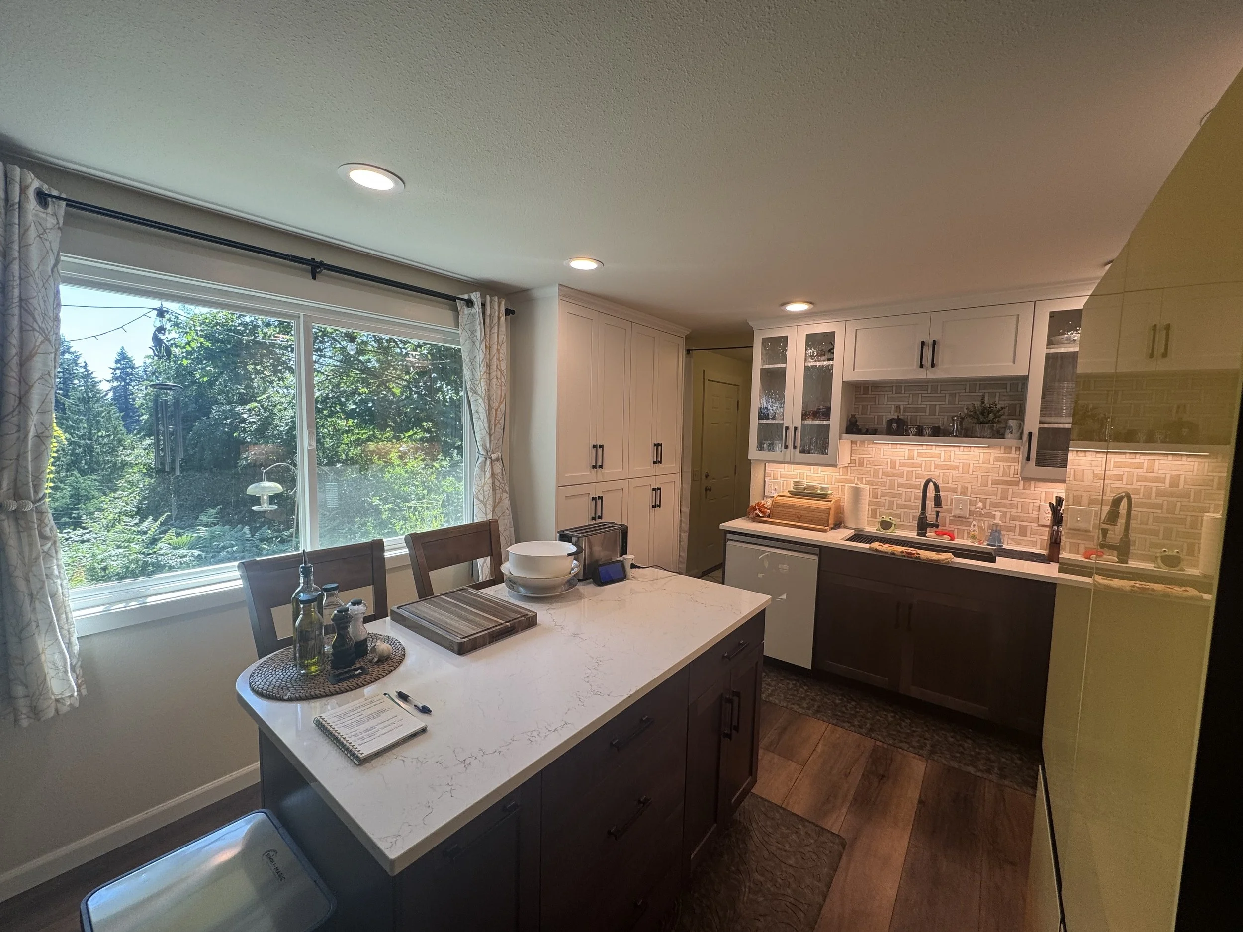remodeled kitchen area after water damage. There is custom cabinets, countertops, and under cabinet lighting.
