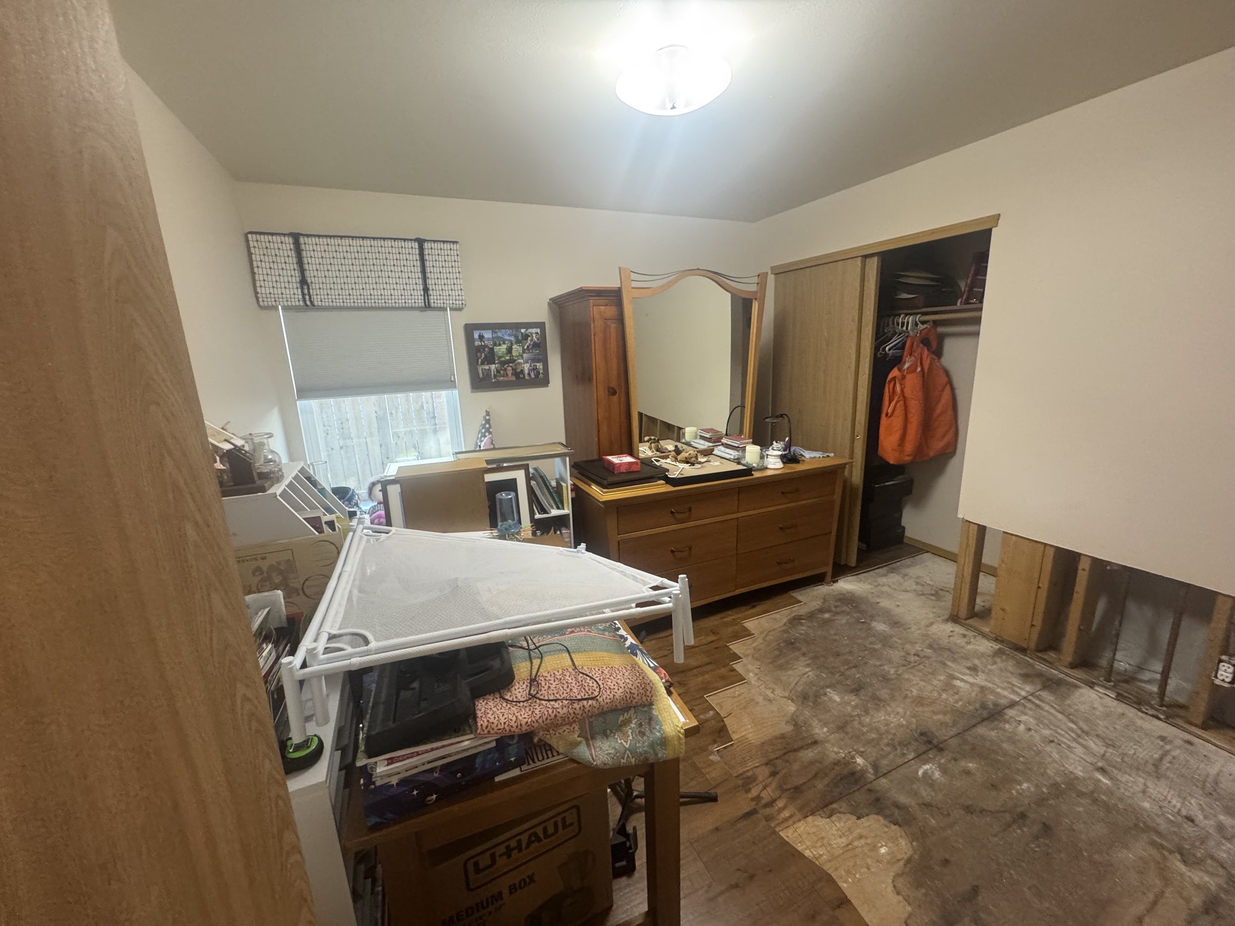 A leaky water heater in Kirkland, WA water damaged this room.