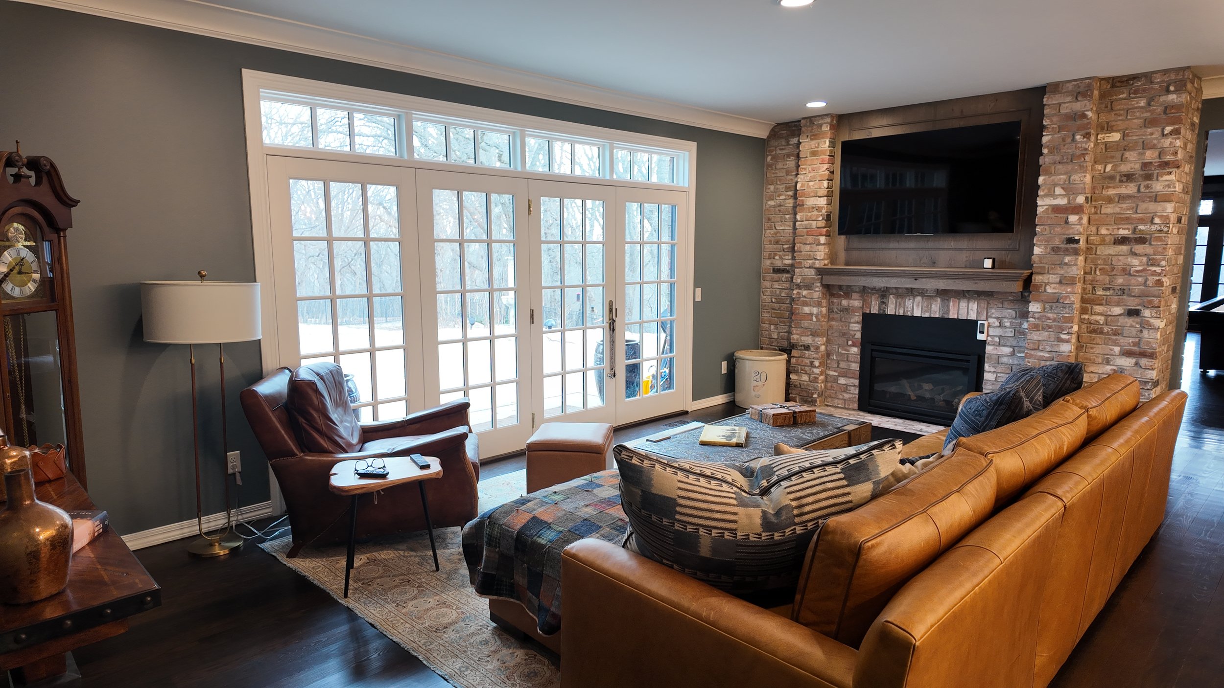 fully furnished living room setup with green paint on walls