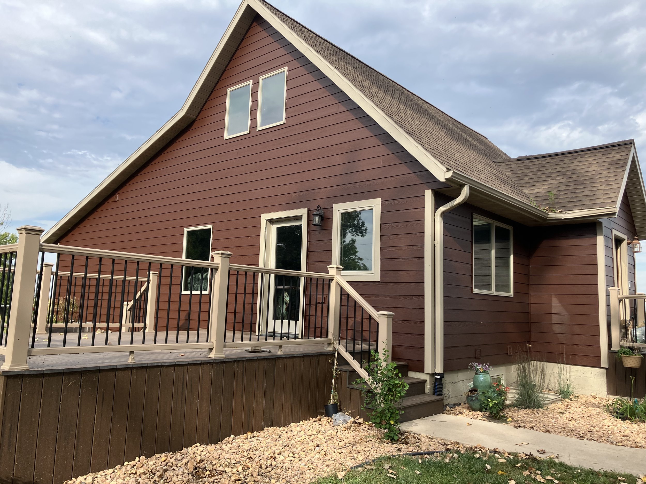 Home with red siding and wooden porch