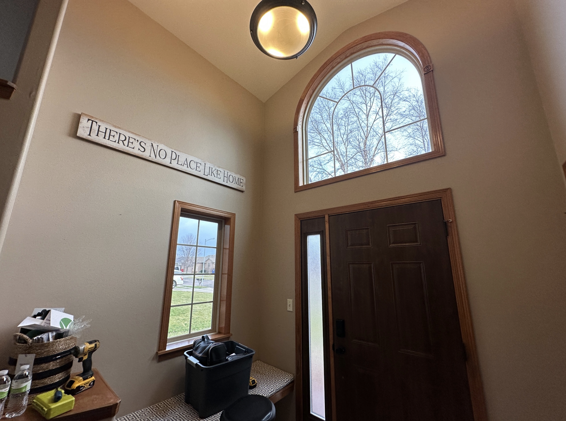 Inside foyer of a home with walls painted tan and brown trim