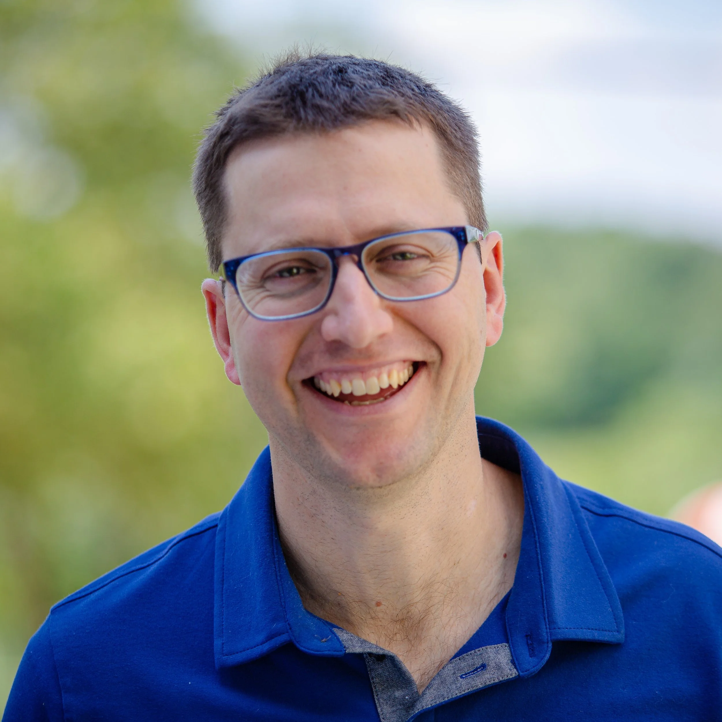 Matt Guernsey outdoors in a green environment.