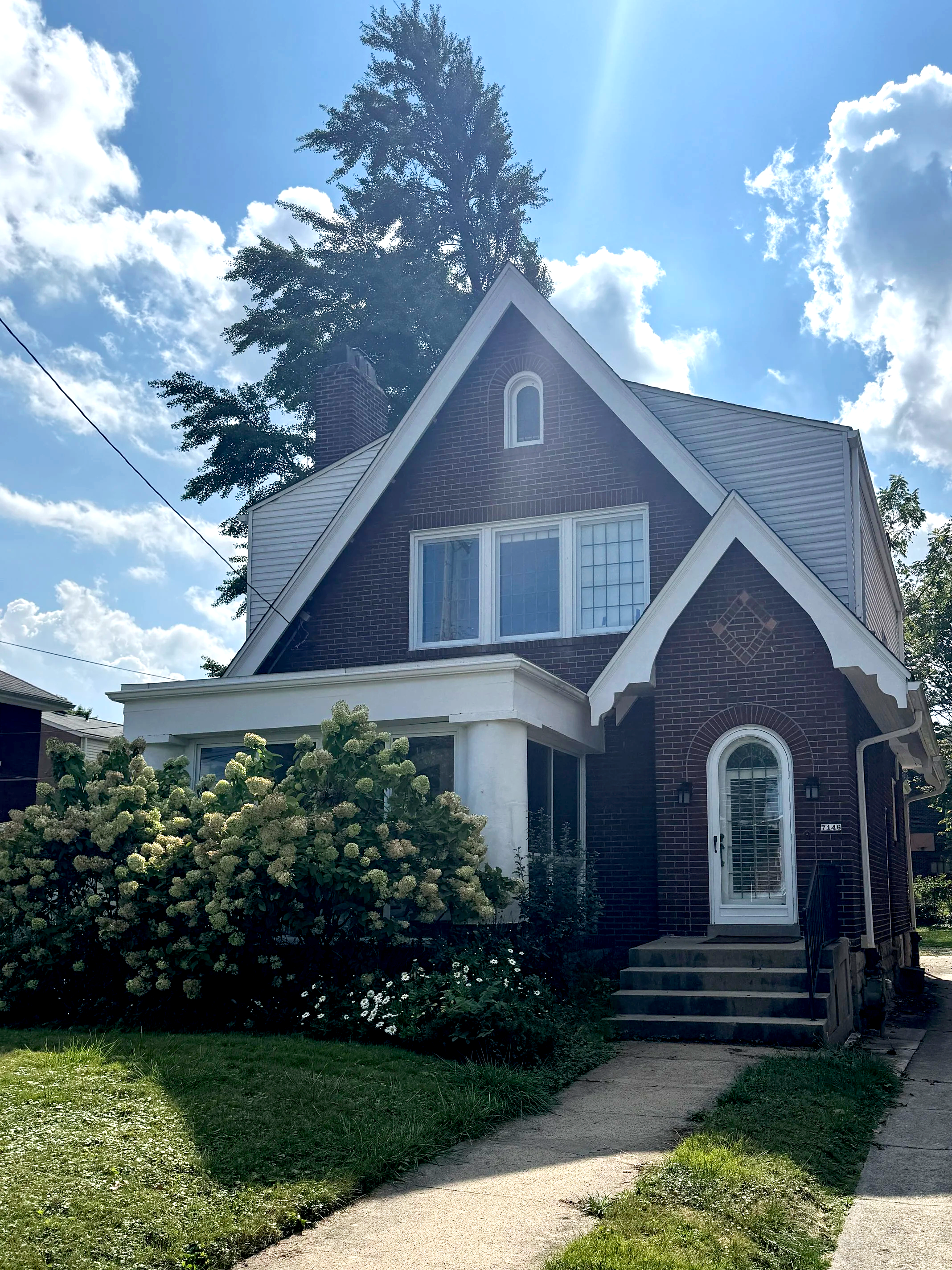 A cottage-style century home in the North Point Breeze neighborhood is adorned with hydrangea and is walkable to Google