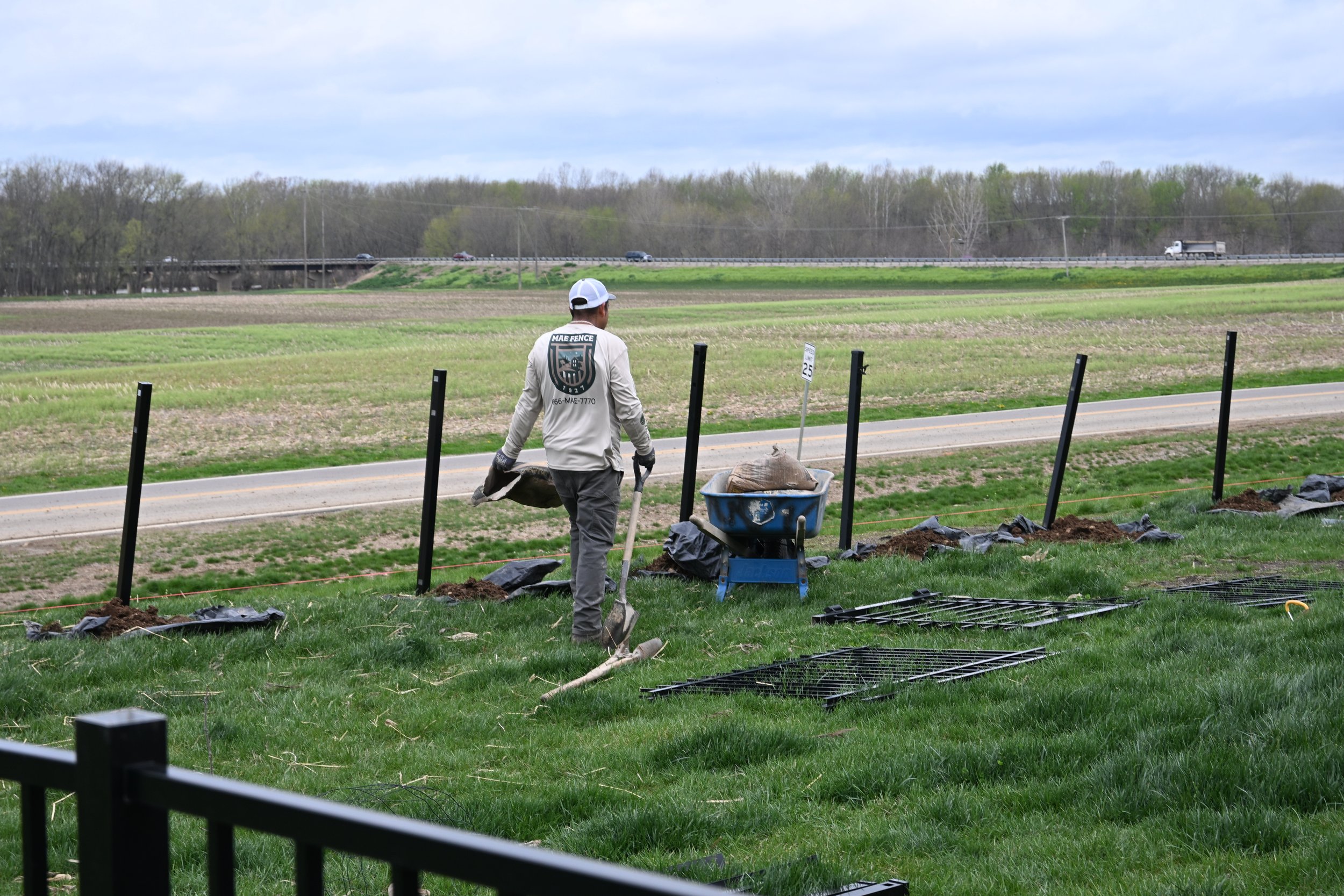 Mae Fence Employee installing black aluminum fence in Columbus, Ohio