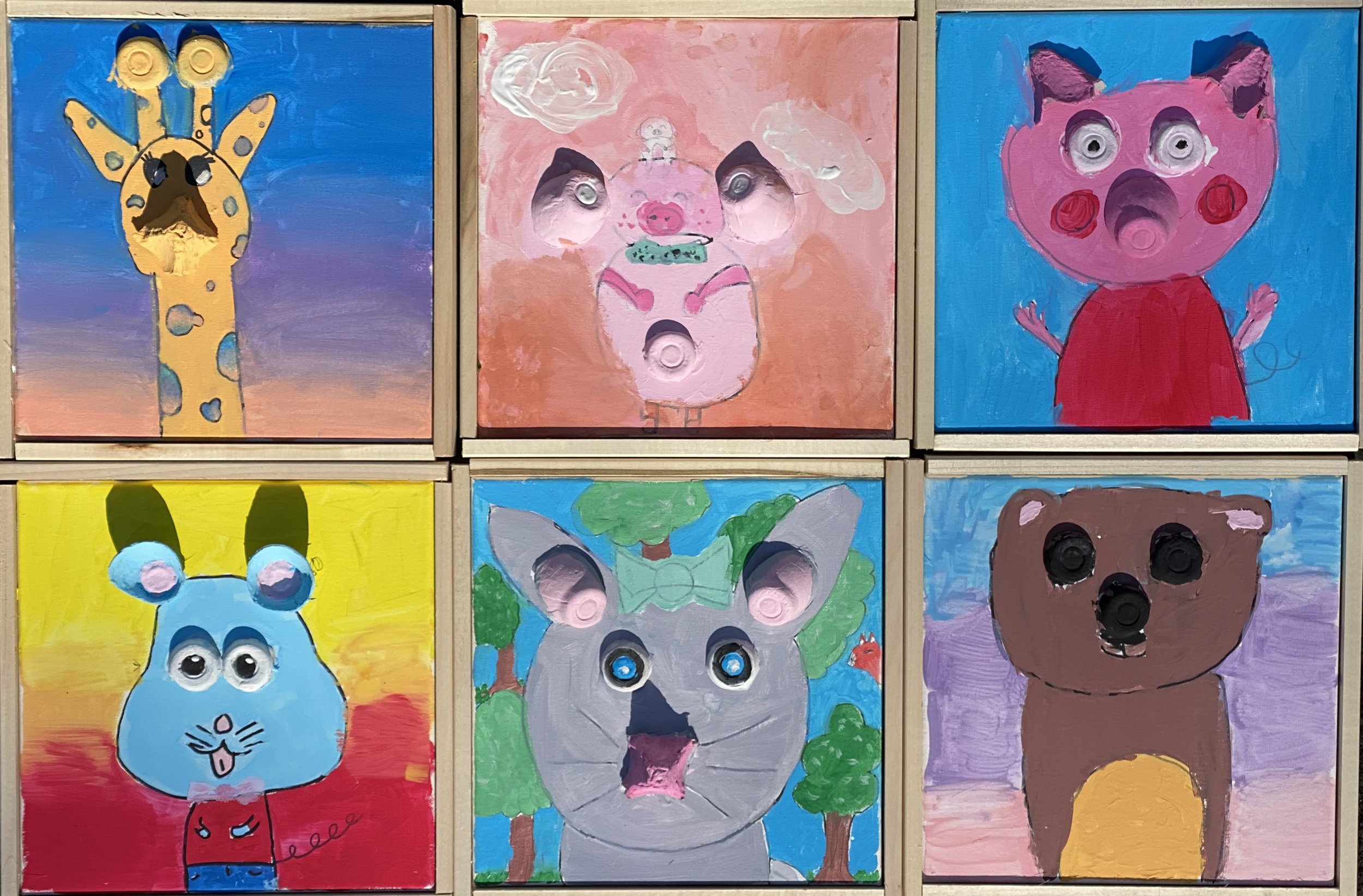 Six colorful children's paintings of animals, each with googly eyes attached. The animals include a giraffe, pig, pig, rabbit, wolf, and bear, with backgrounds in various shades of blue, pink, yellow, and purple.