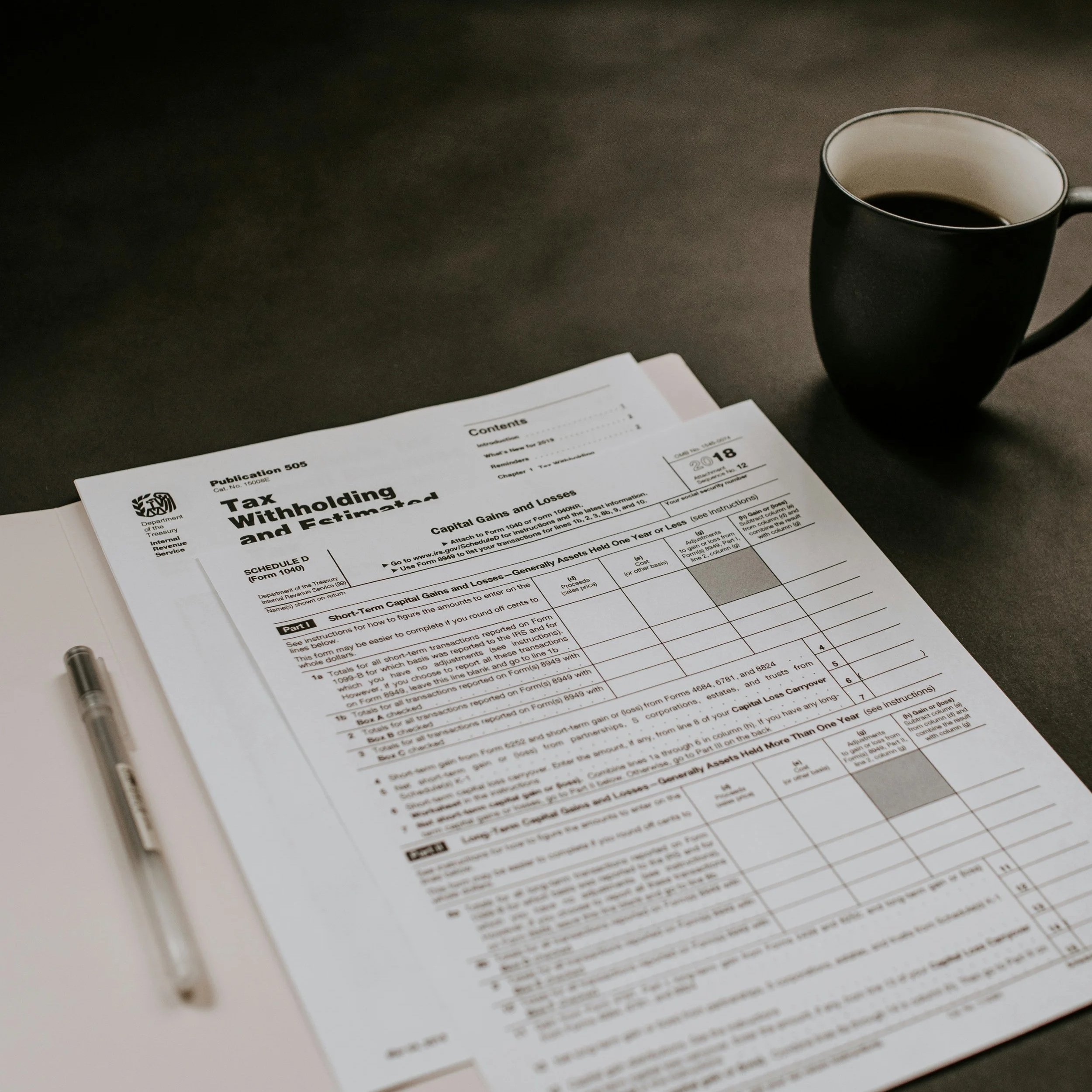 Tax preparation - coffee cup next to tax forms