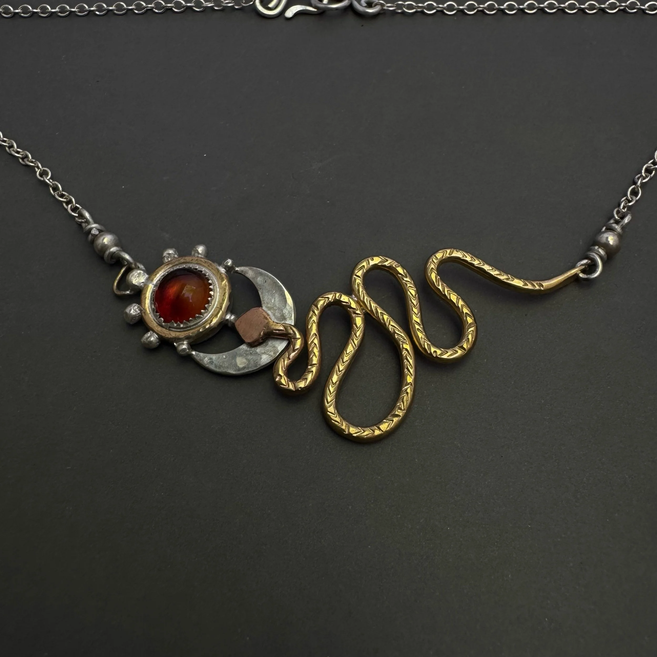 handmade symbolic necklace with sun moon and serpent