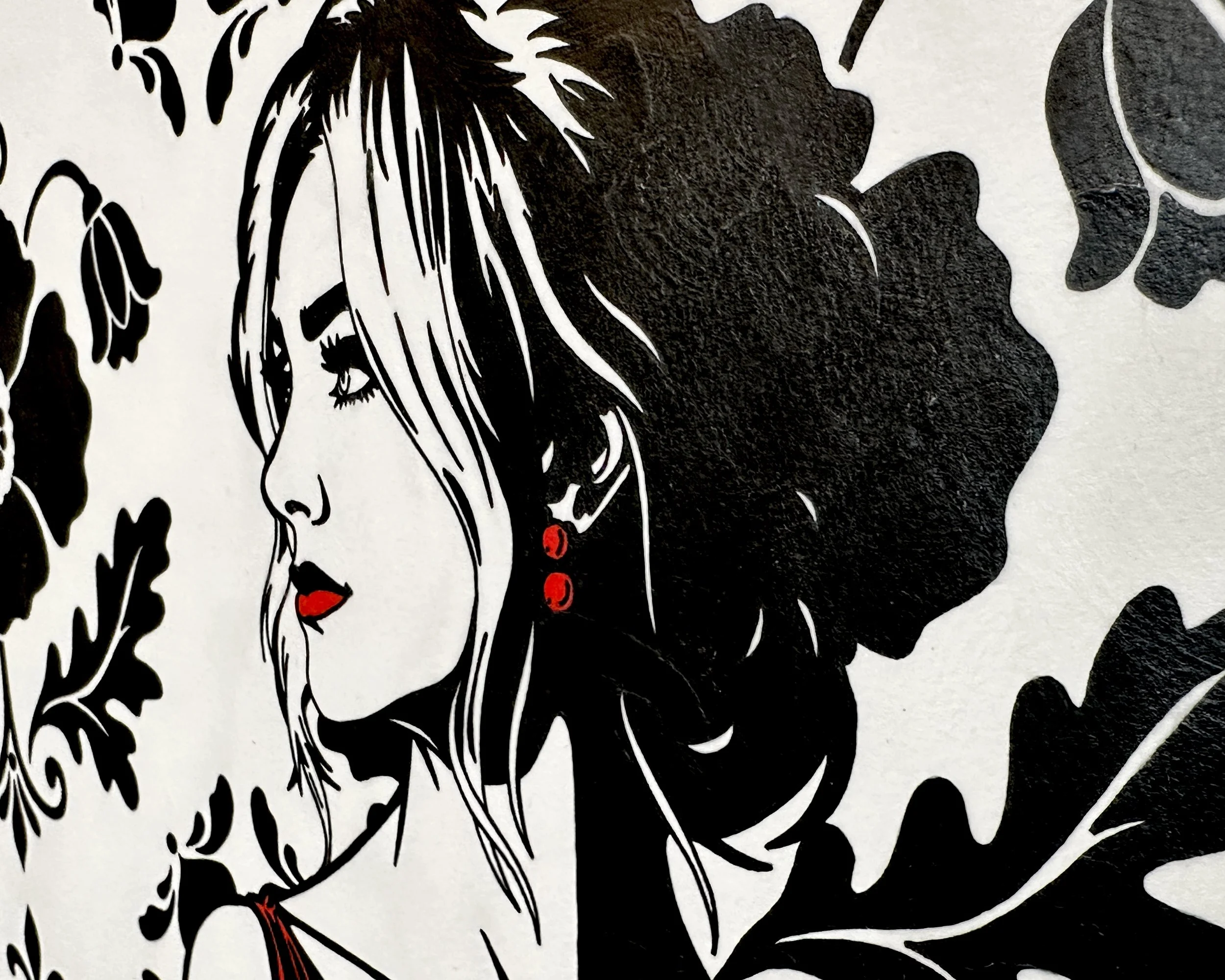 Artist Brett Hodges at Quiet Corner Art Studio, Omaha, NE, close-up detail of A Promise to Herself showing the bride’s side profile, red lips, red earrings, black and white line work, and floral background.
