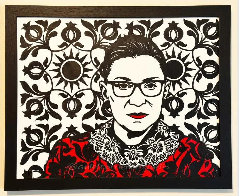 Original framed painting titled RBG featuring a pop art portrait of Ruth Bader Ginsburg with her dissent collar and a patterned background by Omaha artist.