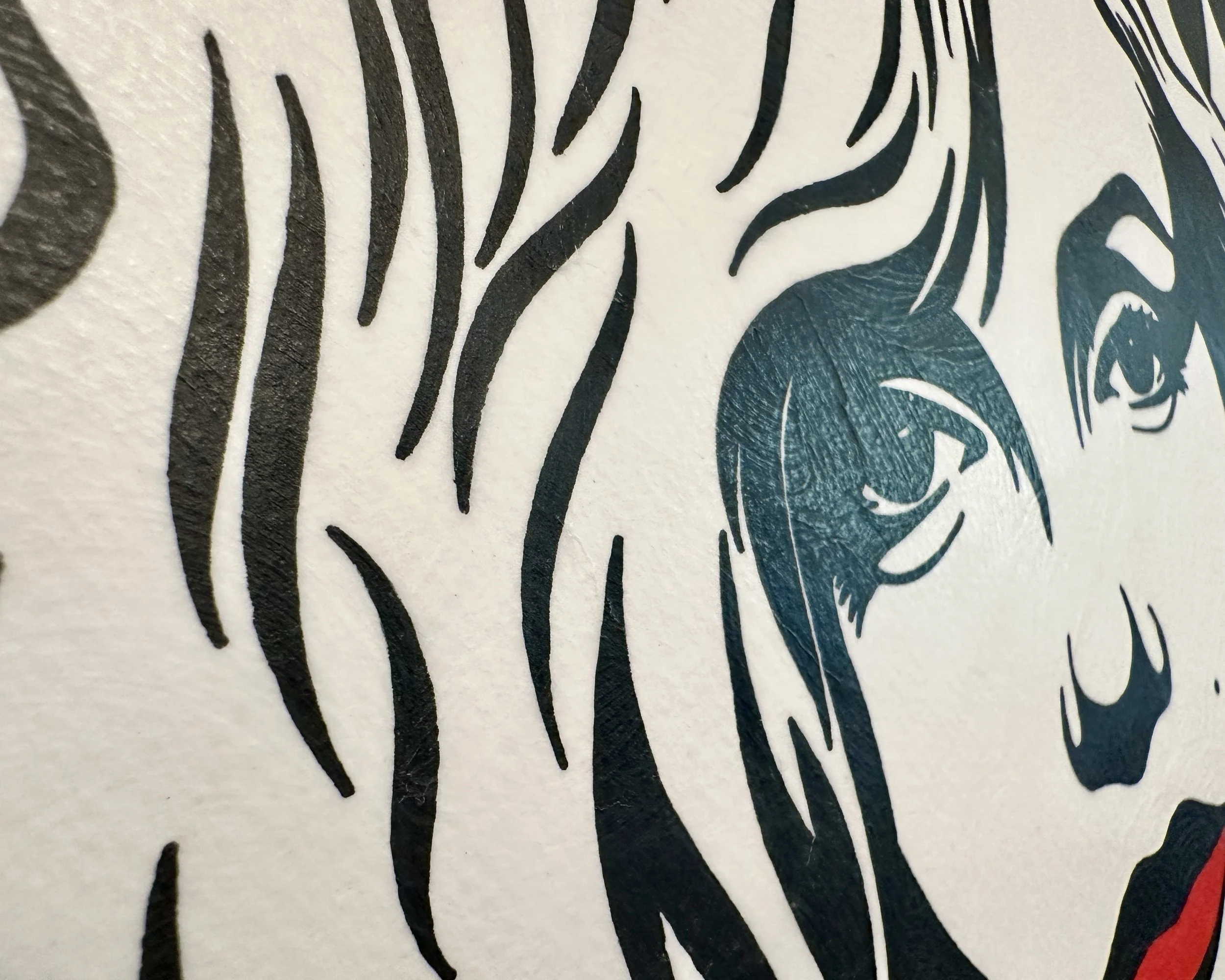 Angled macro photography showing the matte texture of gouache sealed with Dorland’s wax and the depth of the black textured frame.