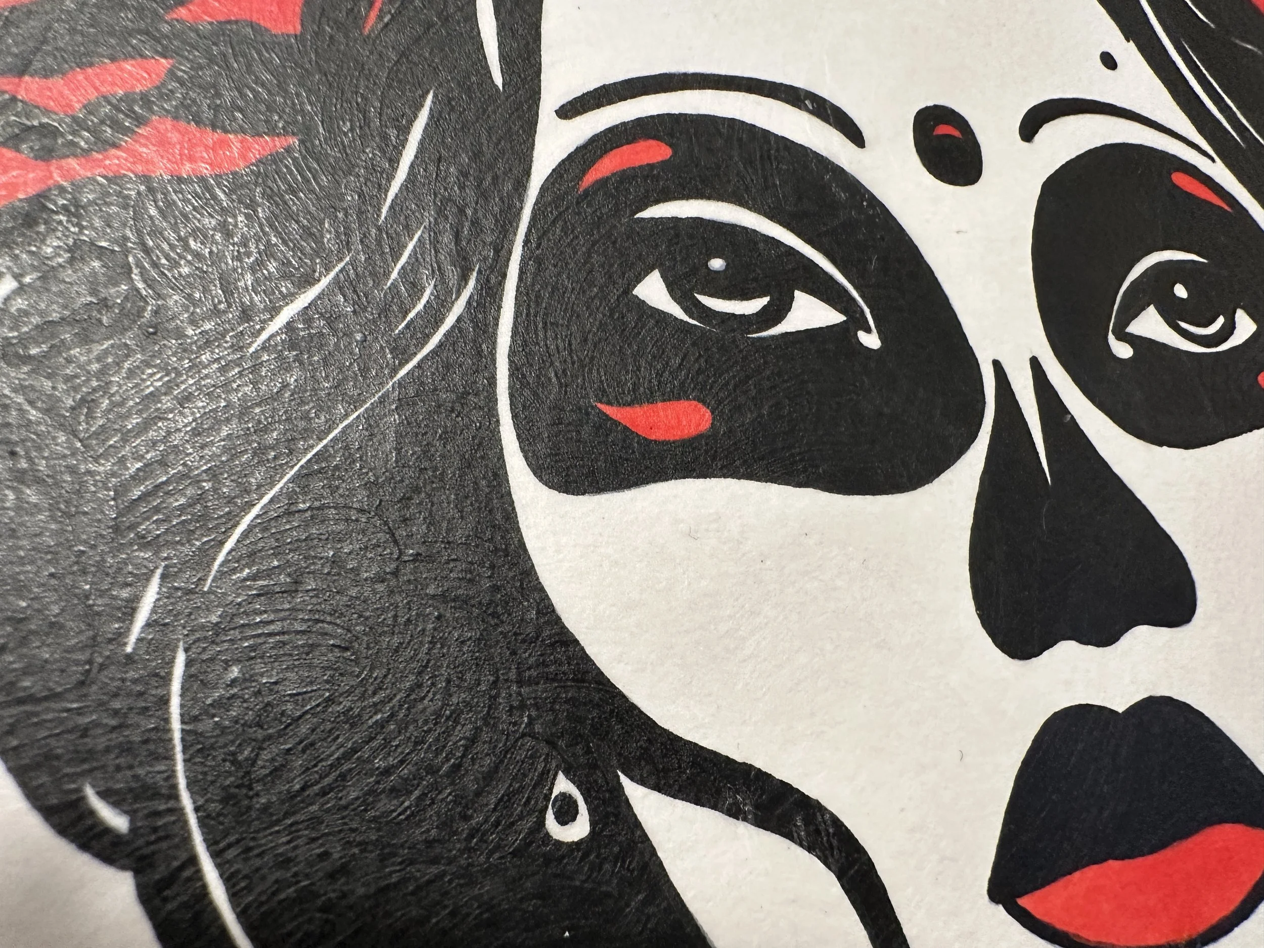 Close up detail of sugar skull makeup and a vibrant crown of red roses on a modern Day of the Dead portrait.