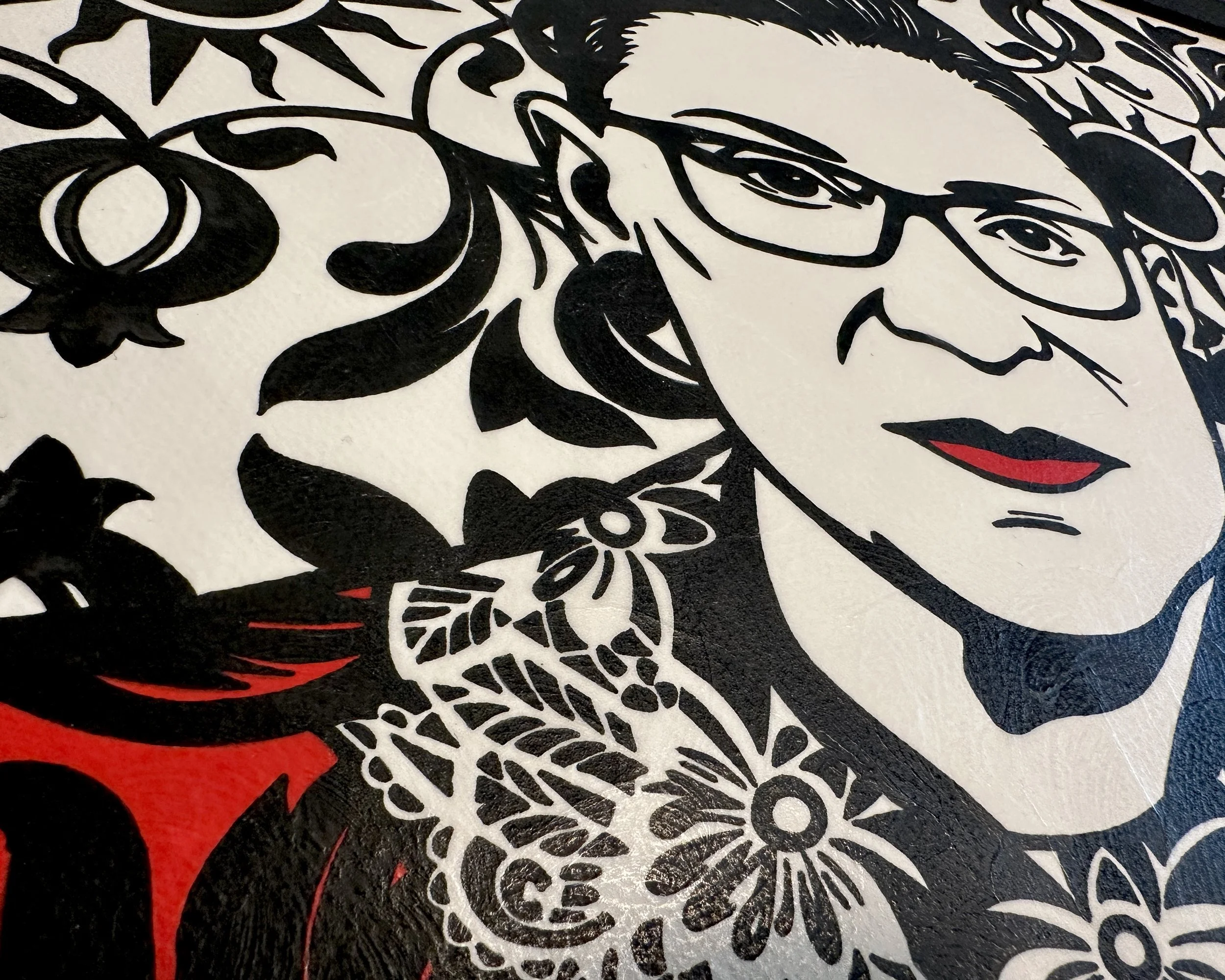 Artist Brett Hodges at Quiet Corner Art Studio, Omaha, NE, original gouache Pop Art portrait of Ruth Bader Ginsburg with bold black and white contrast and red accents.