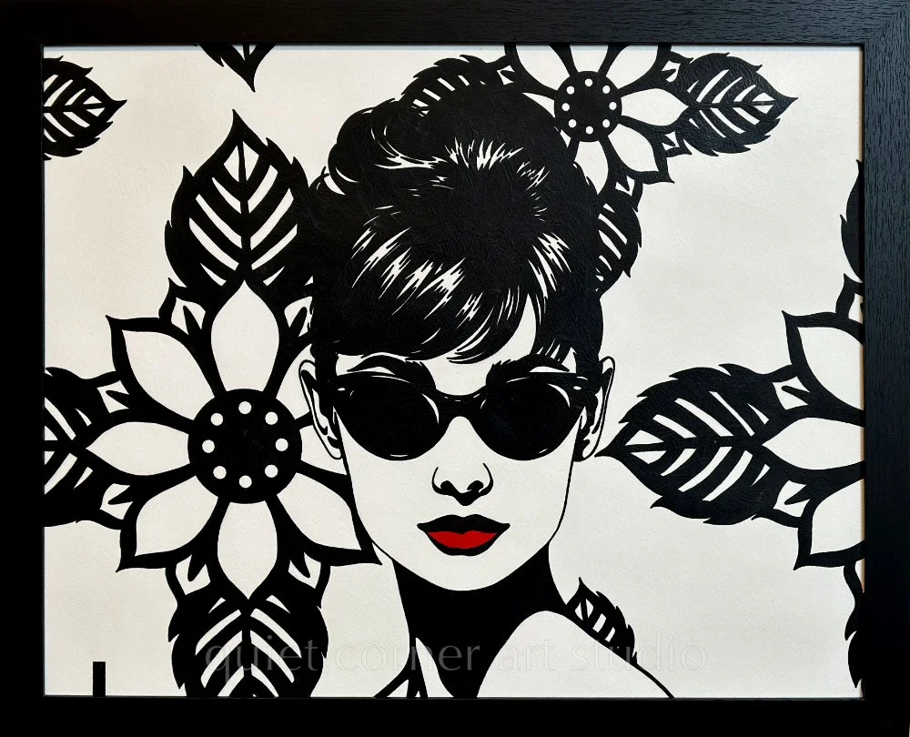 Artist Brett Hodges at Quiet Corner Art Studio, Omaha, NE, original gouache Pop Art portrait inspired by Audrey Hepburn and Breakfast at Tiffany’s with bold black and white linework and red accents.
