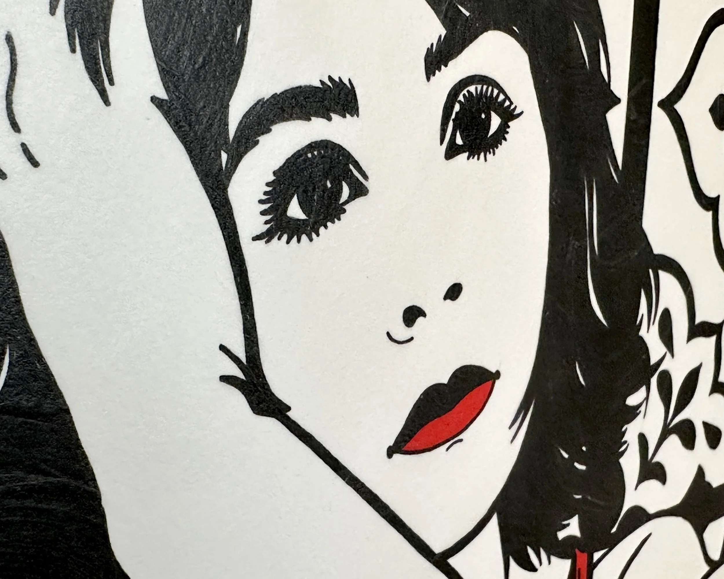 Artist Brett Hodges at Quiet Corner Art Studio, Omaha, NE, close detail of Before the Beginning showing the bride’s eyes, red lips, facial line work, and surrounding background pattern.