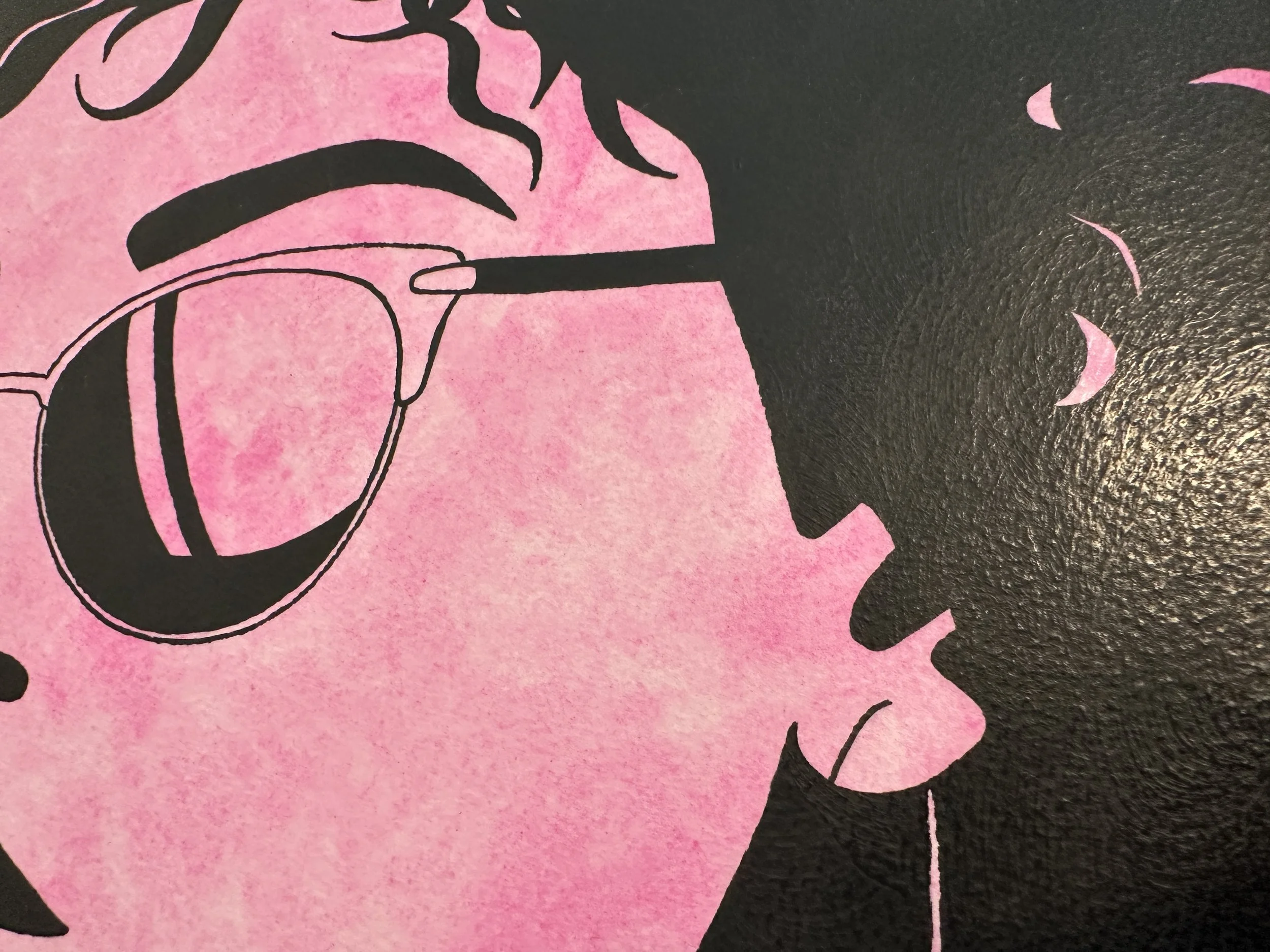 Side view of the textured black frame showing the archival mounting without glass.