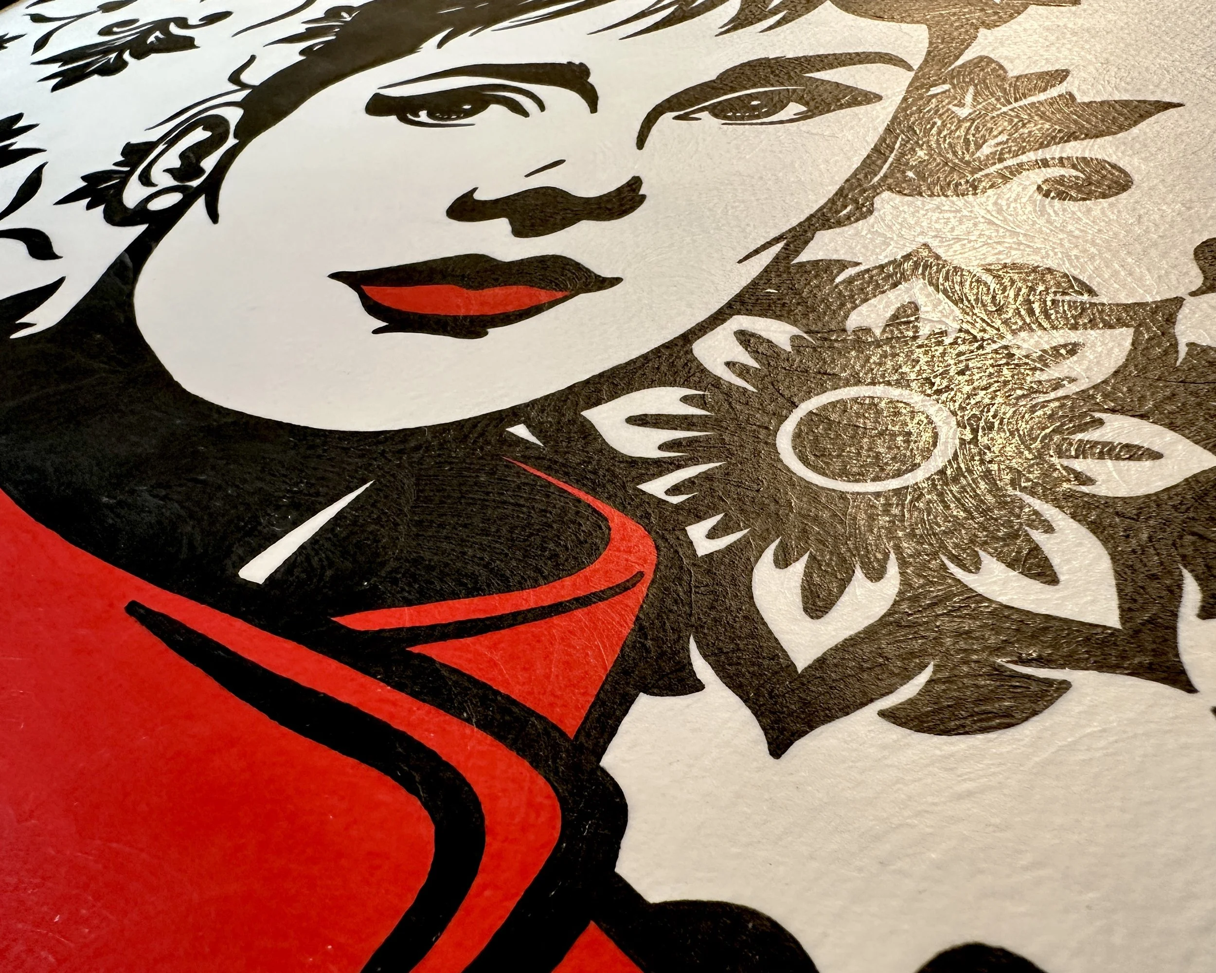 Artist Brett Hodges at Quiet Corner Art Studio, Omaha, NE, original gouache Pop Art portrait of Audrey Hepburn in a red blouse with bold black and white contrast.