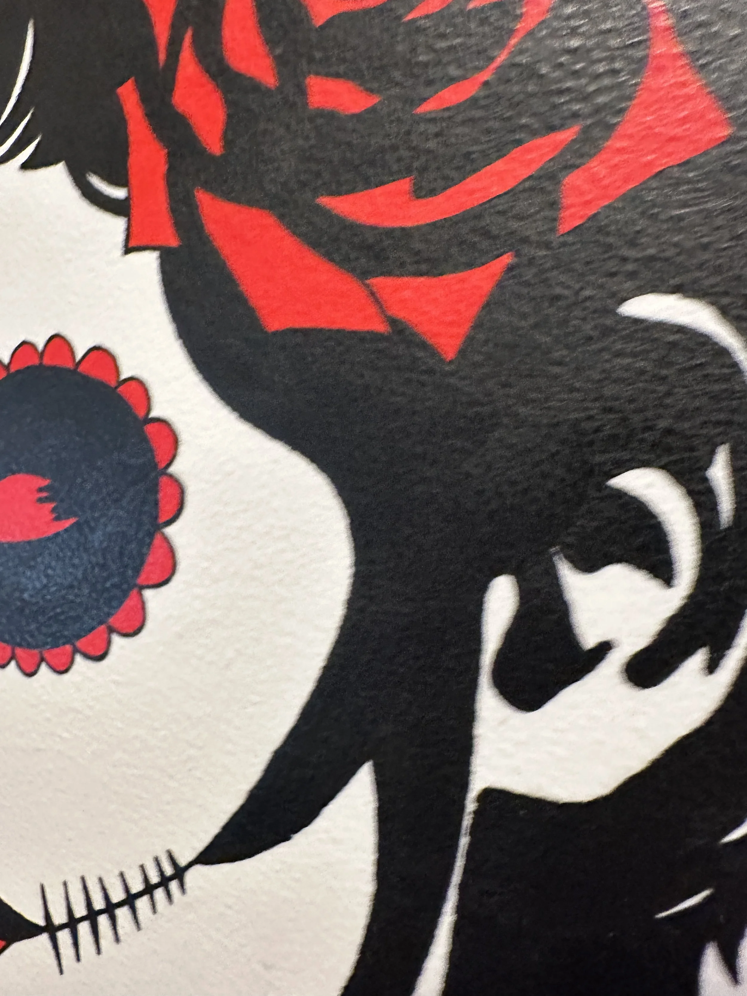 Detail of two vibrant red roses against black hair in a high contrast pop art style.