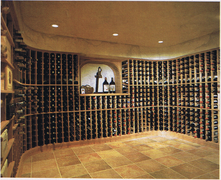 A wine cellar with divided wine racks, a tiled floor, and a shelf with wine bottles and decorative items.
