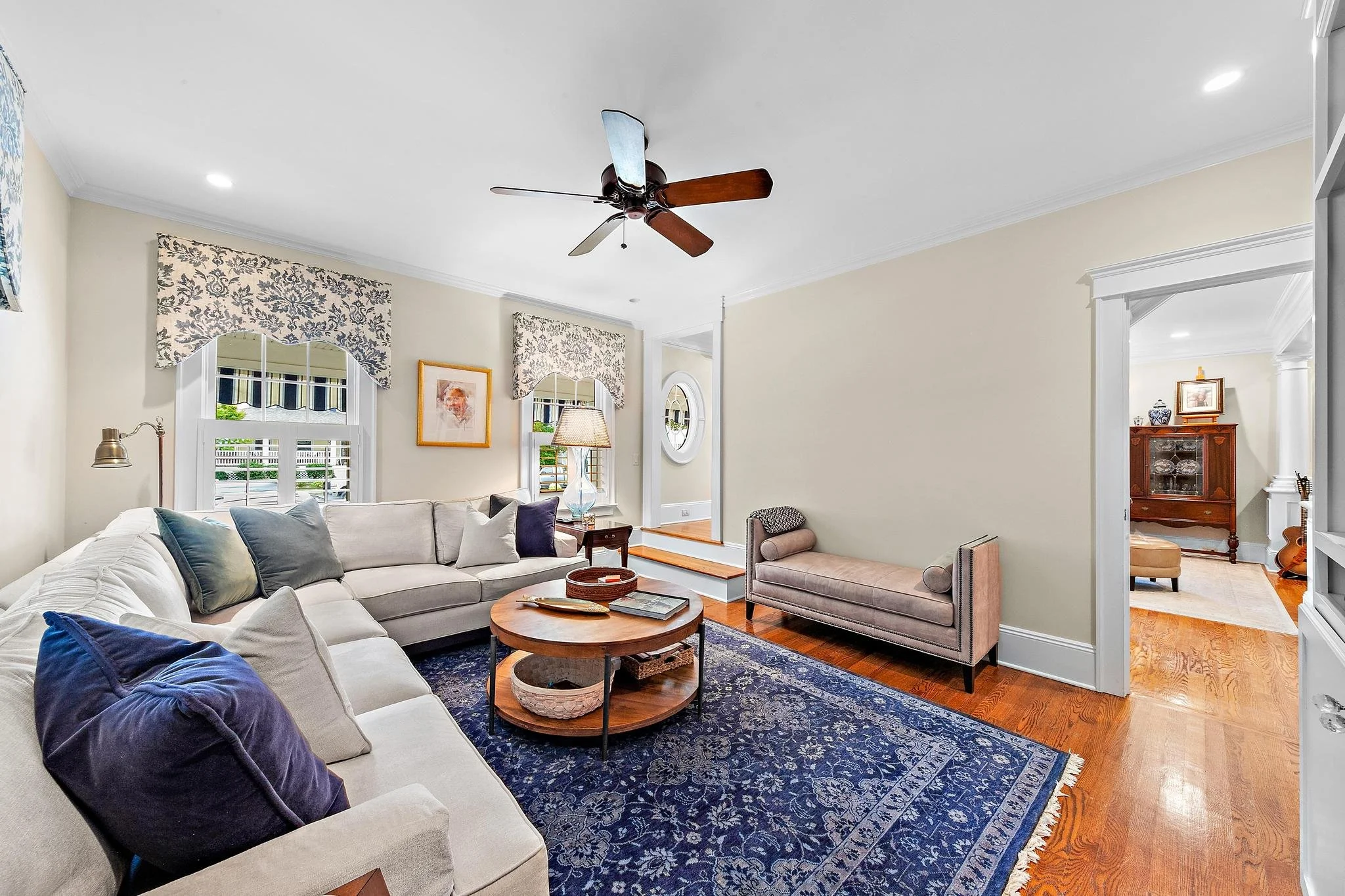 Family Room with beautiful blue carpet, white sectional, open area design.