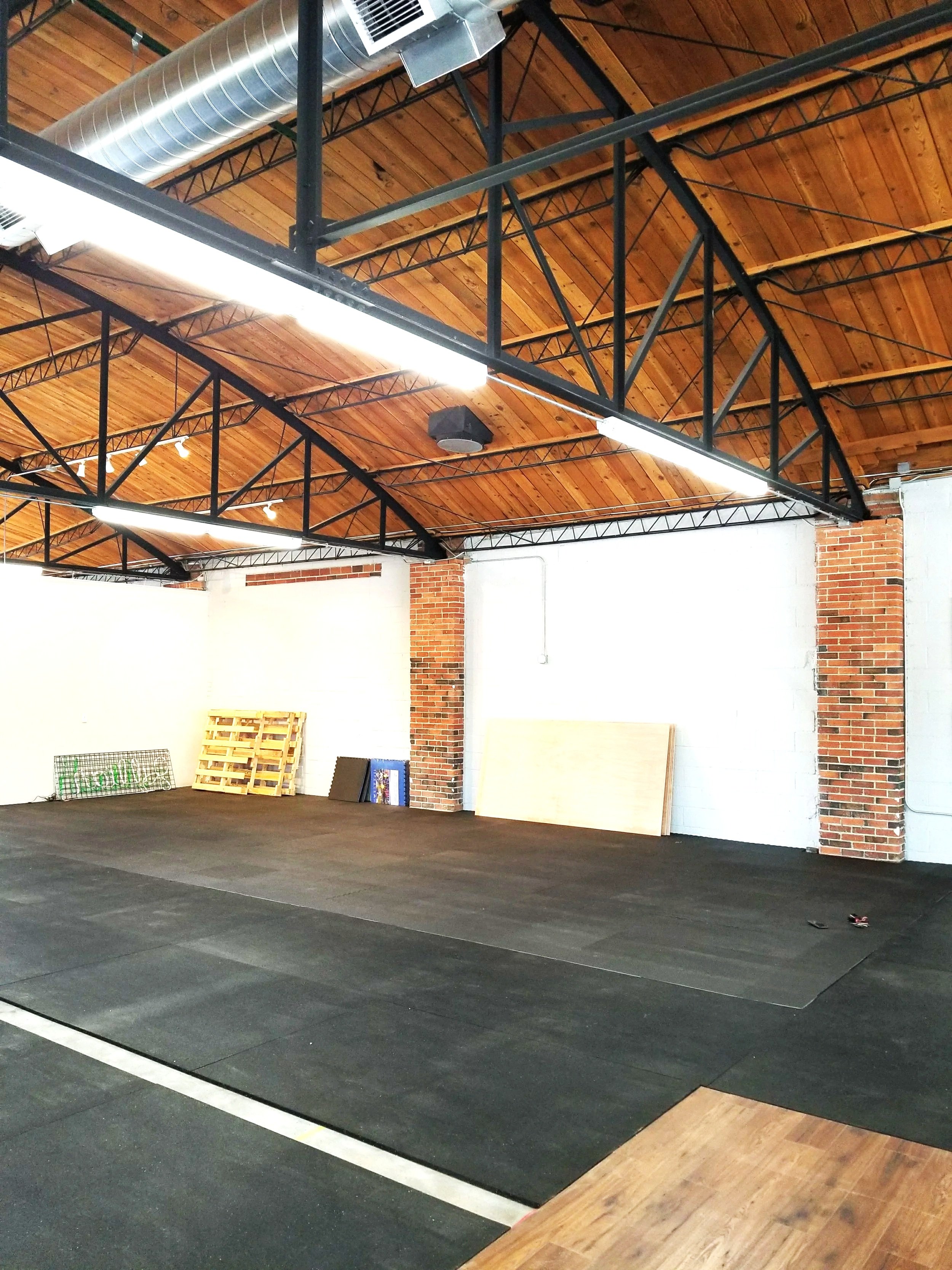 Custom steel interior buildout with exposed trusses and structural framing in Boulder commercial space