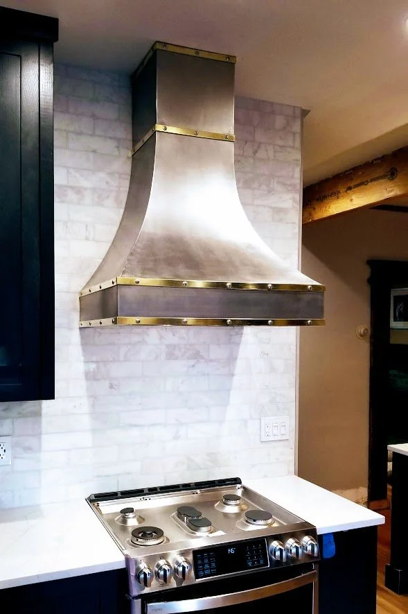 Custom made range hood with bronze and steel