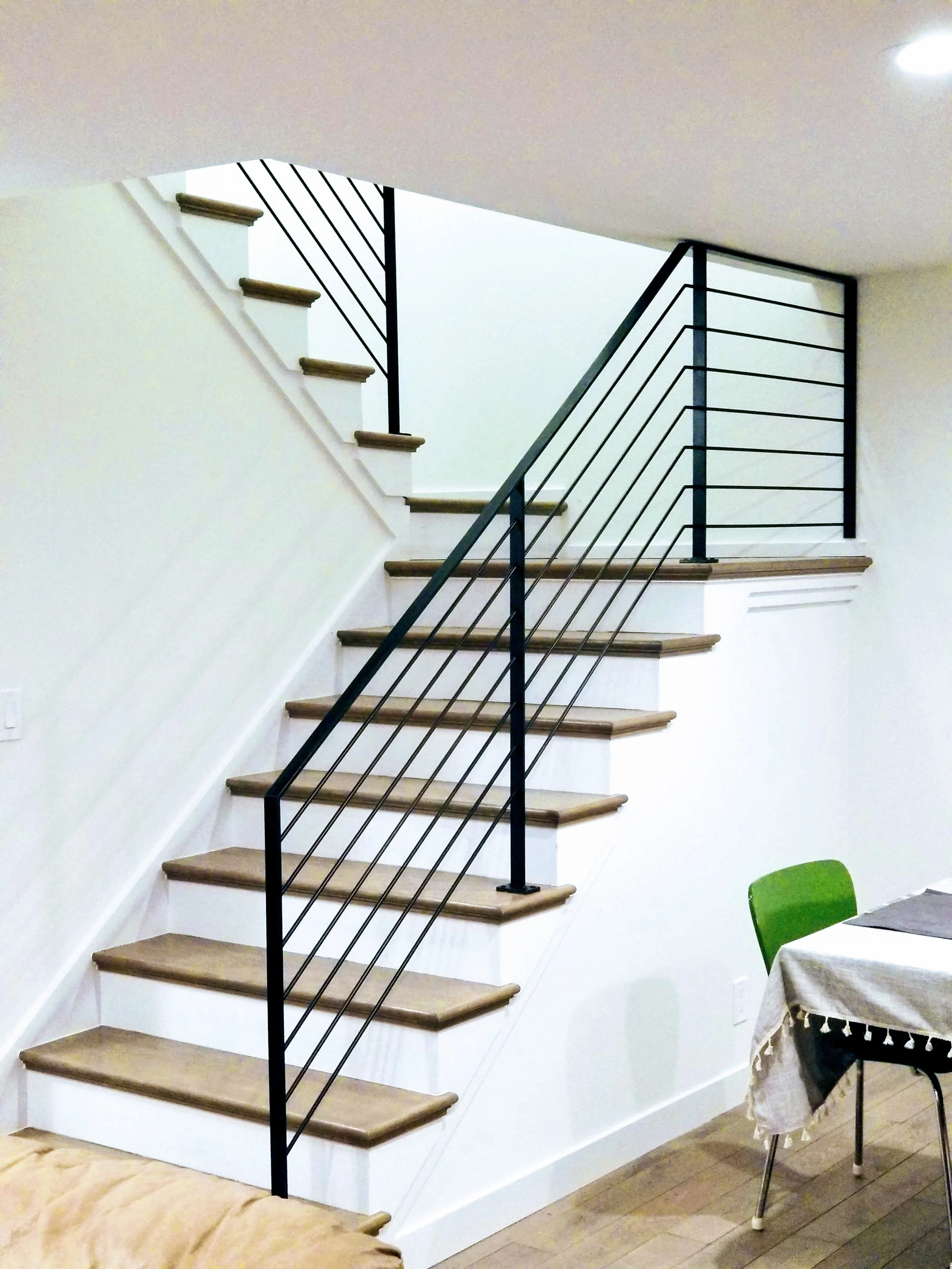 Interior round rod stair railing fabricated and installed for a residential application