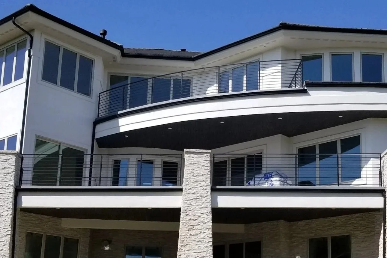 Metal railings on multiple decks of a large gorgeous home