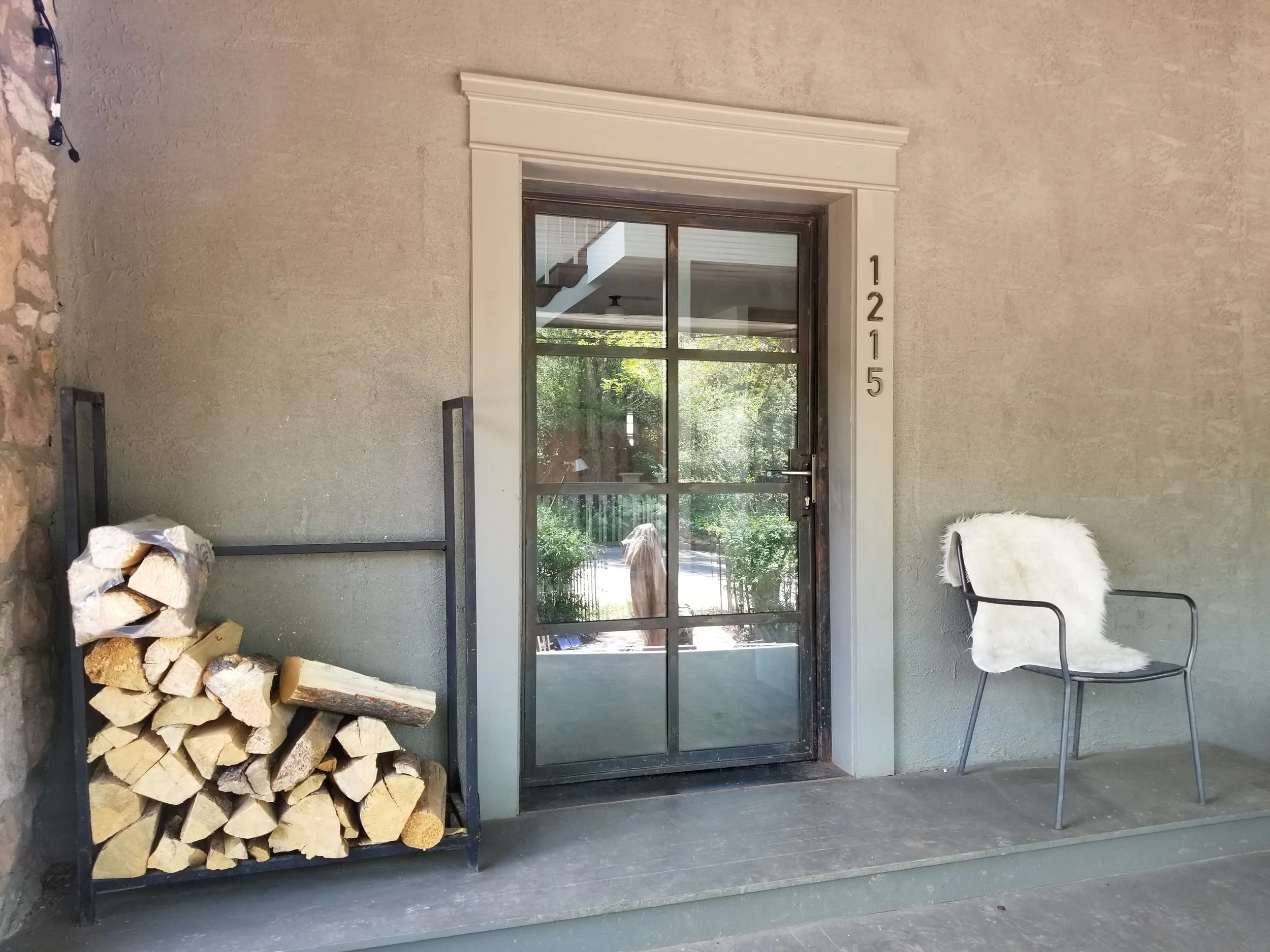 Custom steel and glass residential entry door with divided light panels.