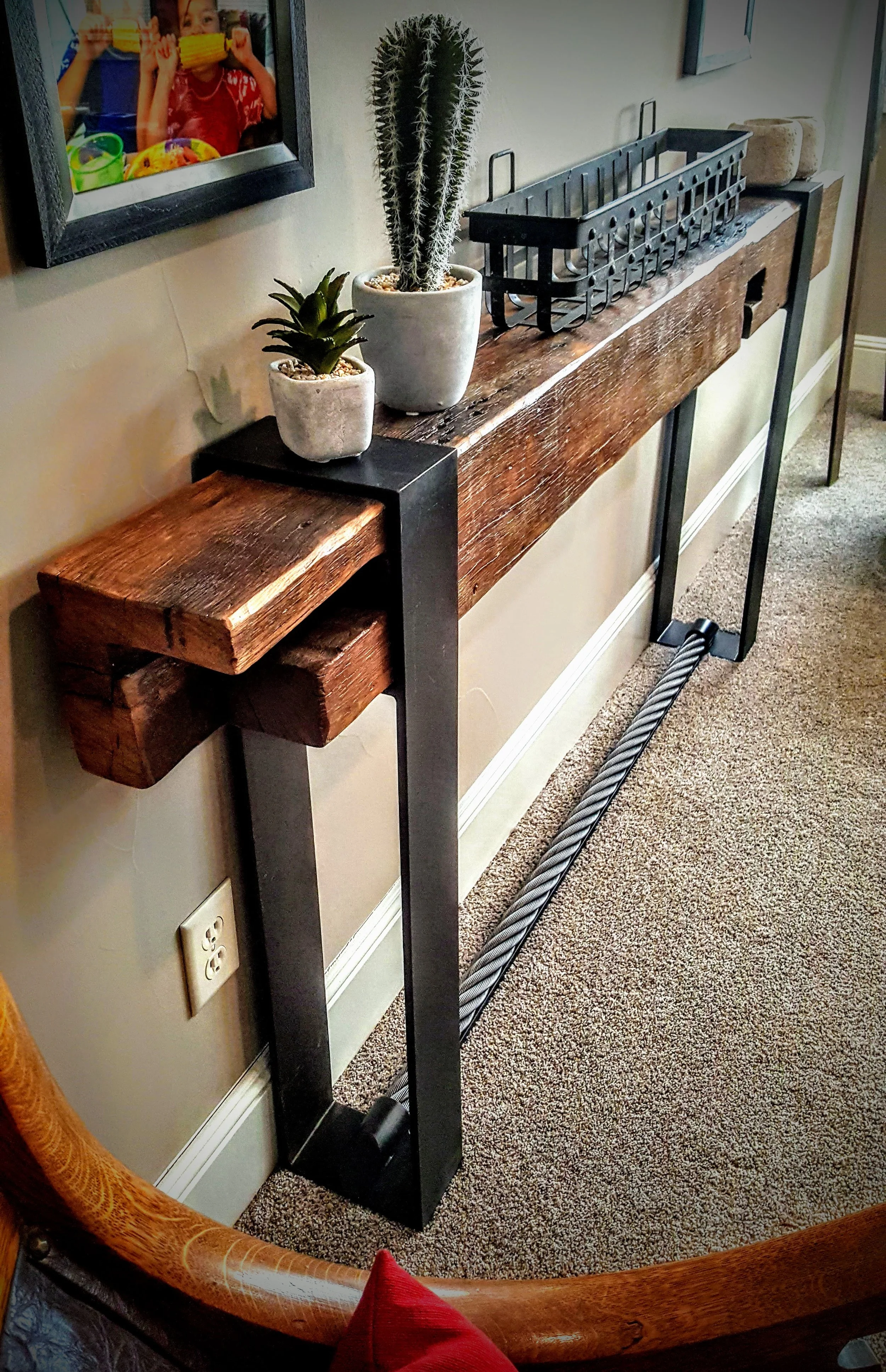 Custom steel and reclaimed wood console table with welded square tube frame and solid timber top in Boulder residence