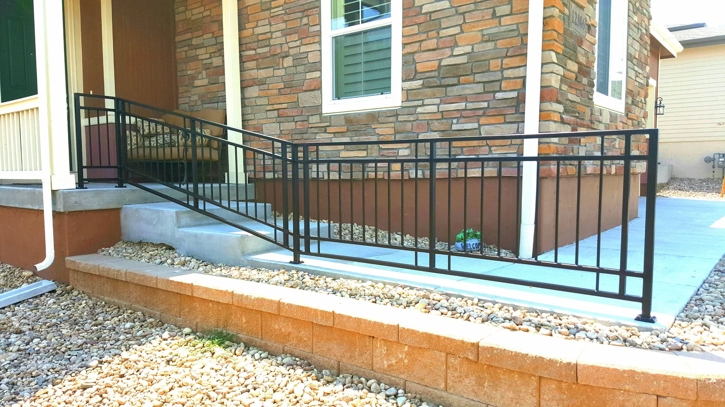 Colorado exterior iron rail of beautiful brick home and the pathway up to the front door