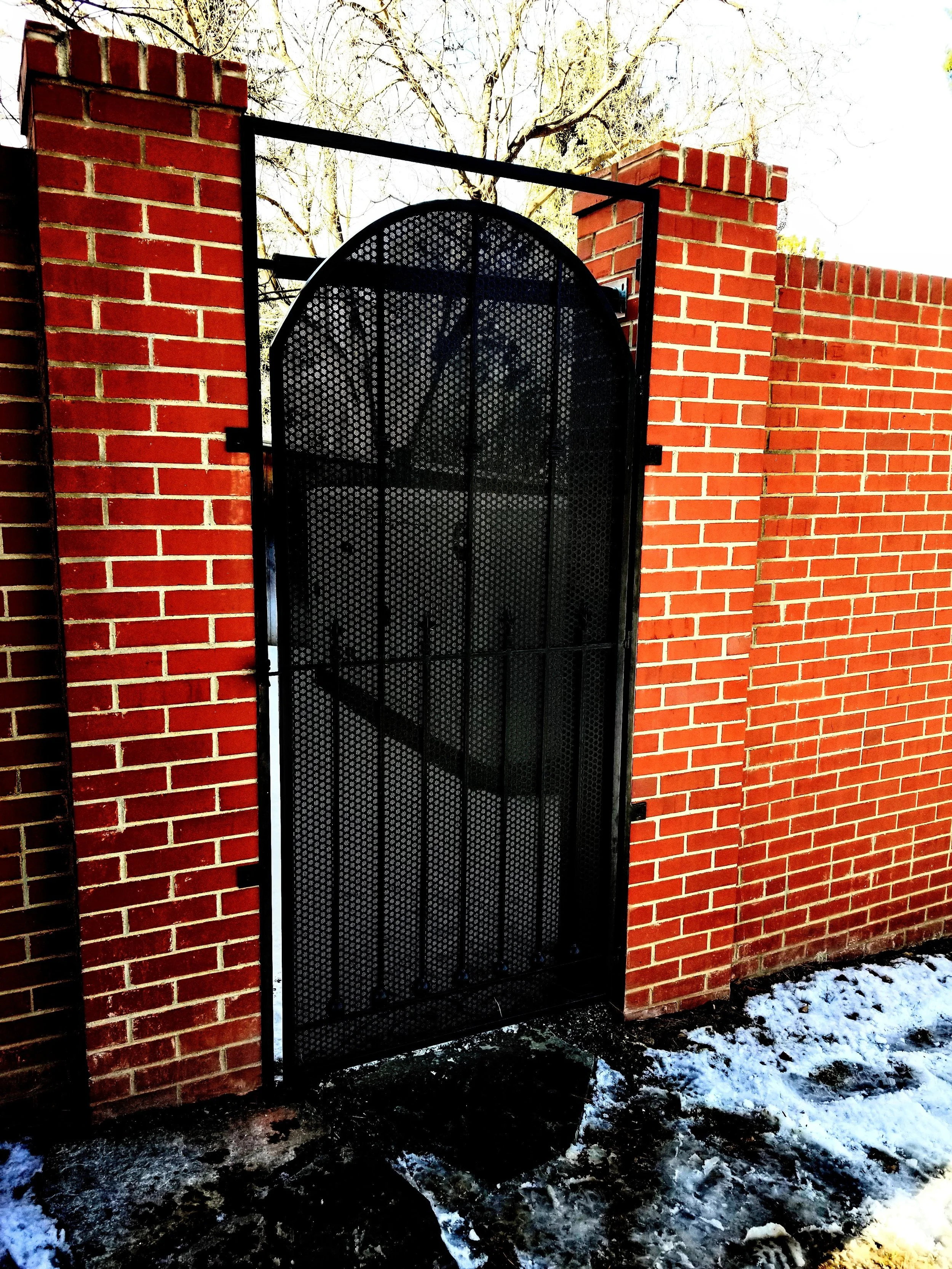 Custom arched steel gate fabricated and installed by Rod and Forge Welding in the Denver metro area