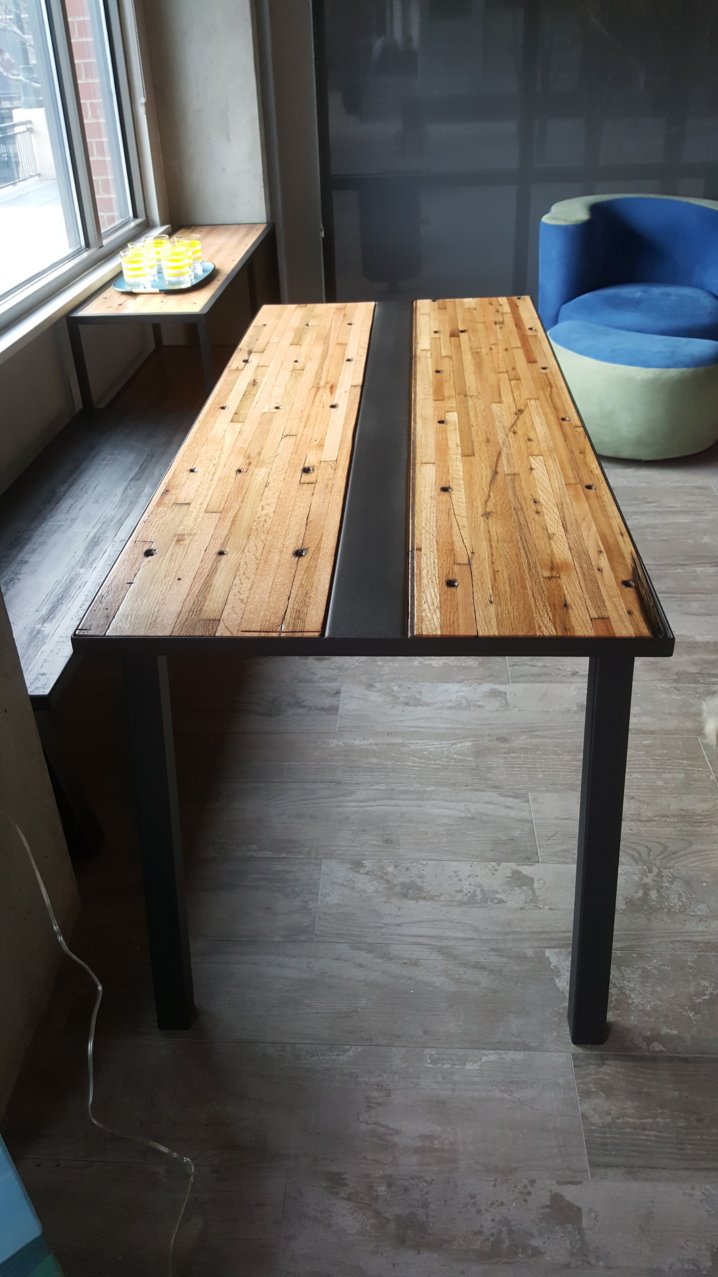Custom fabricated steel and wood table with welded frame in modern Denver interior