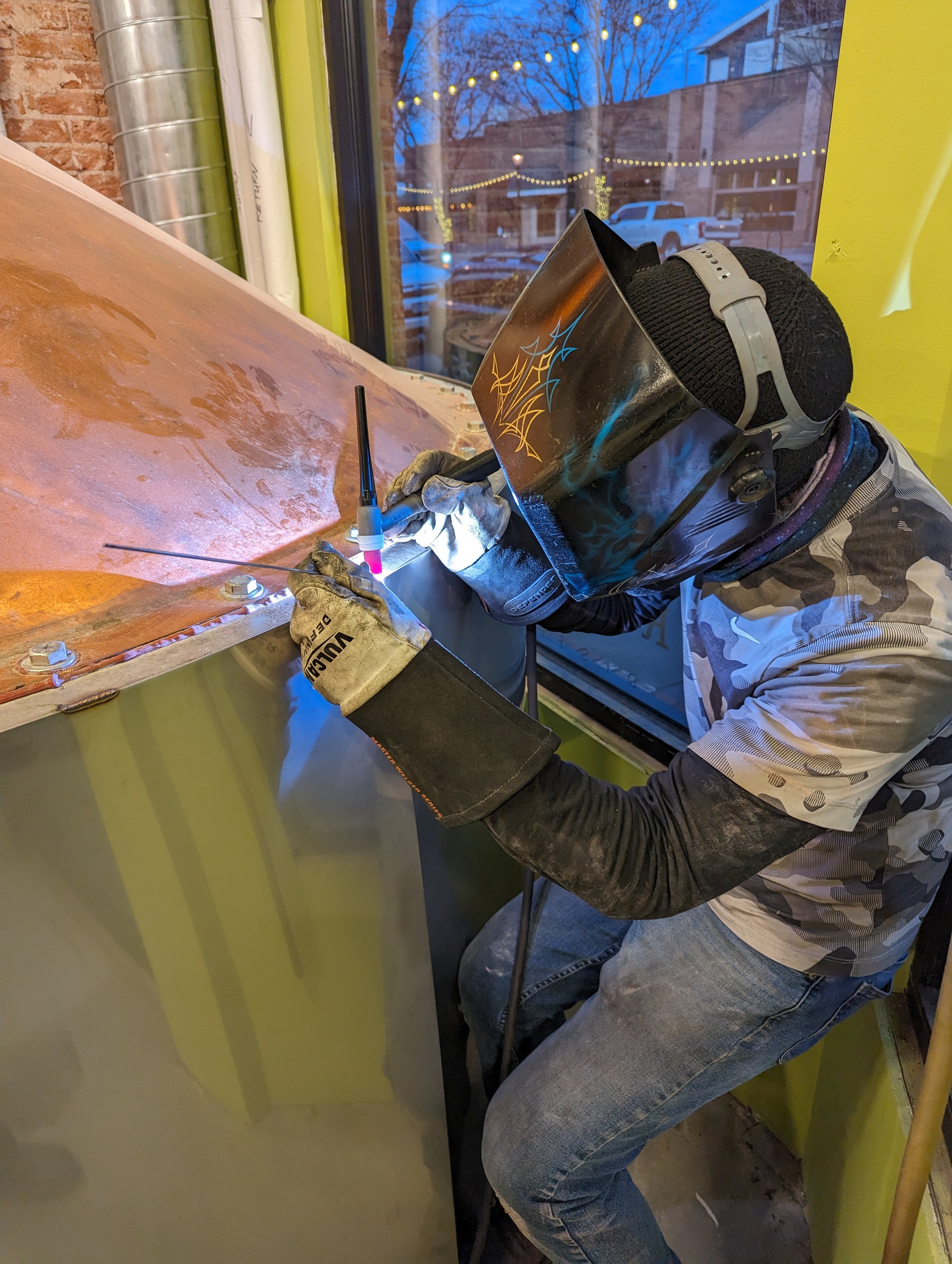 Denver welder TIG welding copper/stainless indoors (helmet down, active weld)